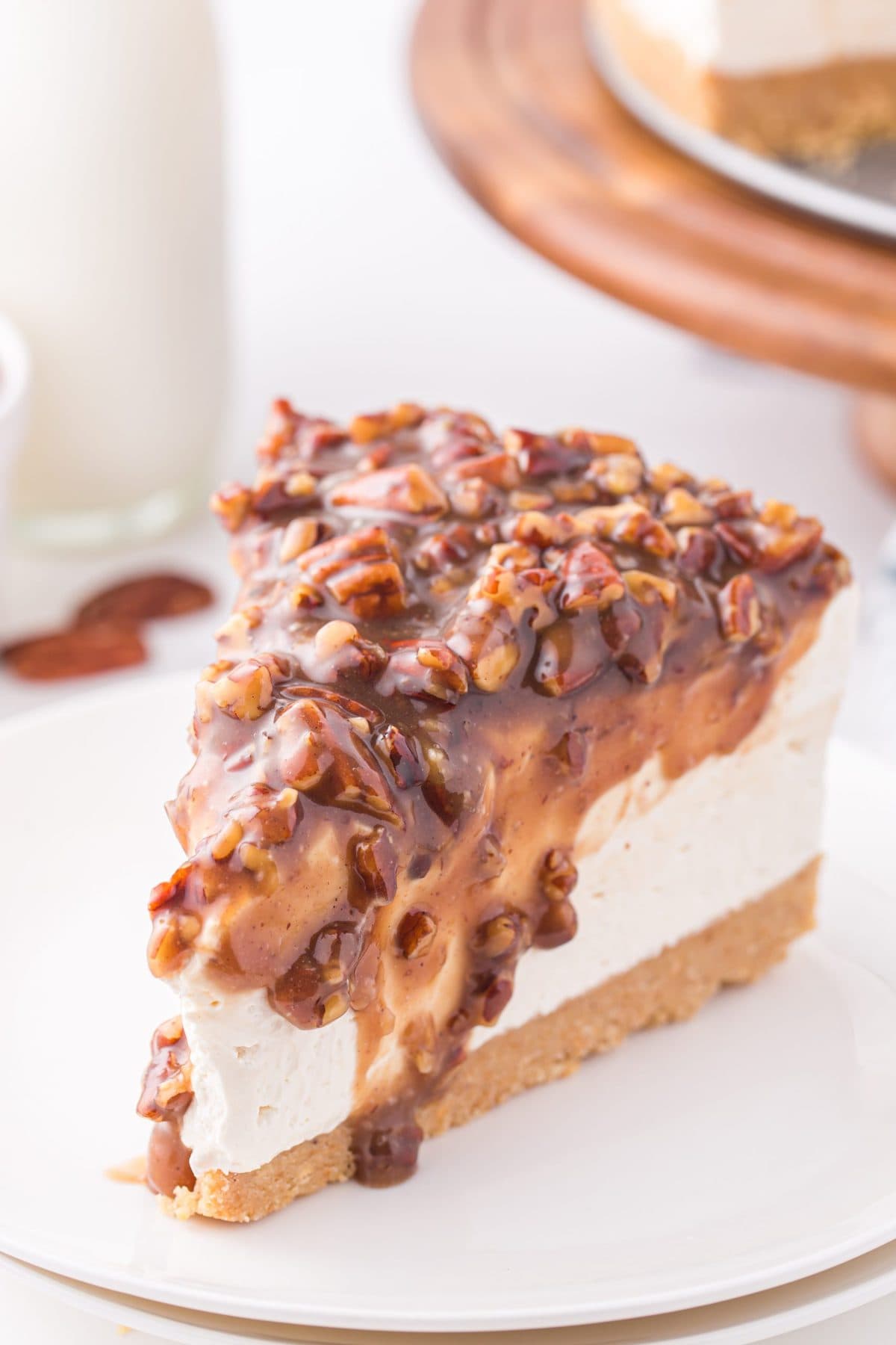 a slice of pecan pie cheesecake on a plate