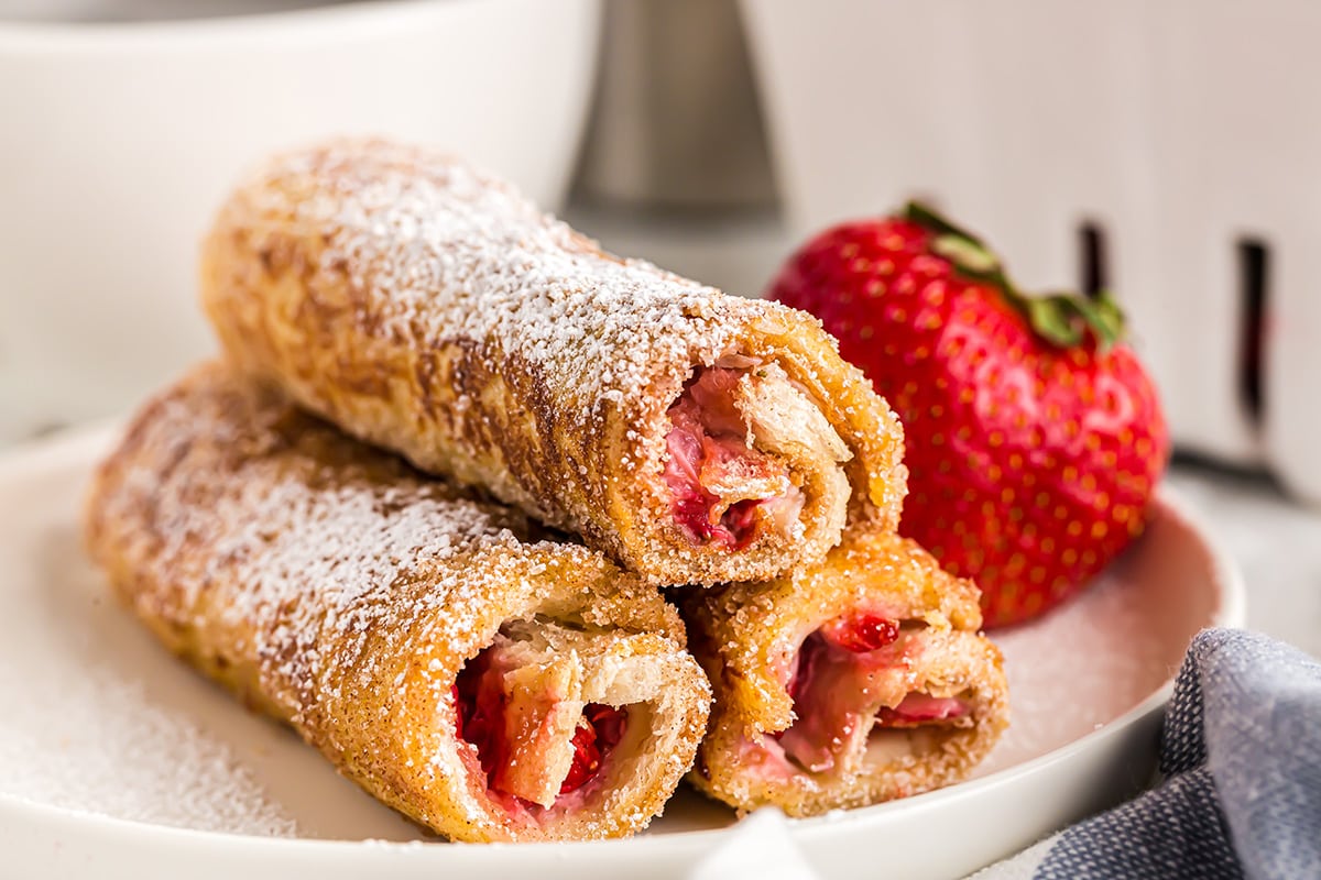 French Toast Rolls-Ups stacked on a plate