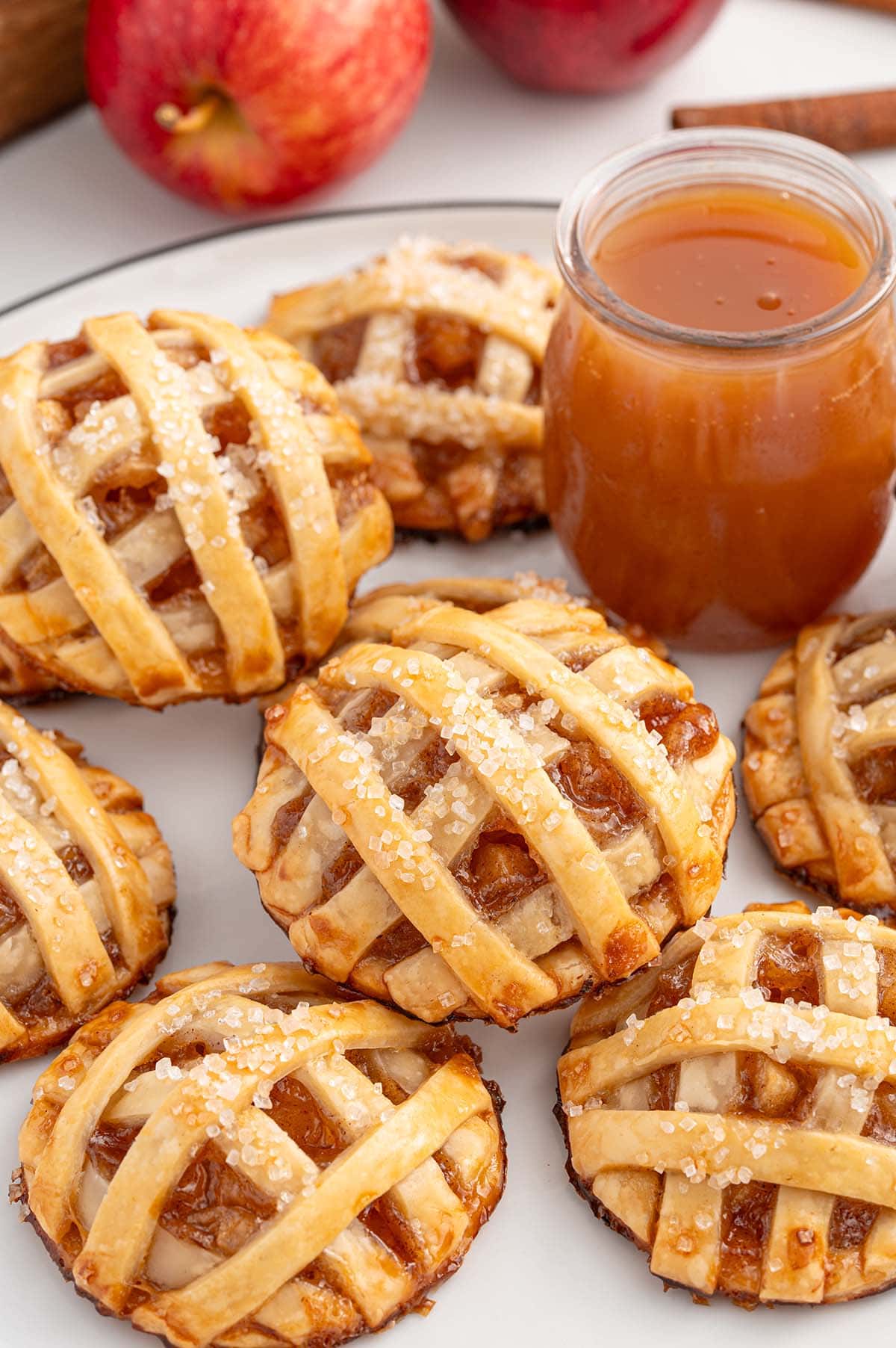 a couple of apple pie cookies on a white plate. 