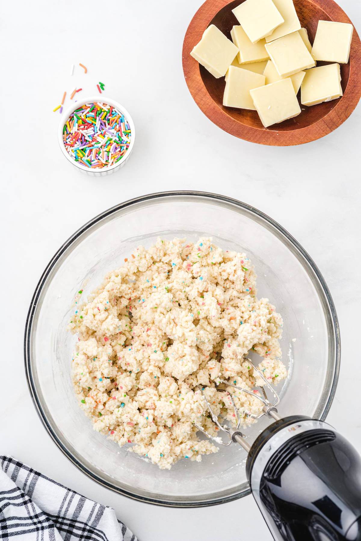 mixing ingredients in the bowl to make no bake cheesecake bites