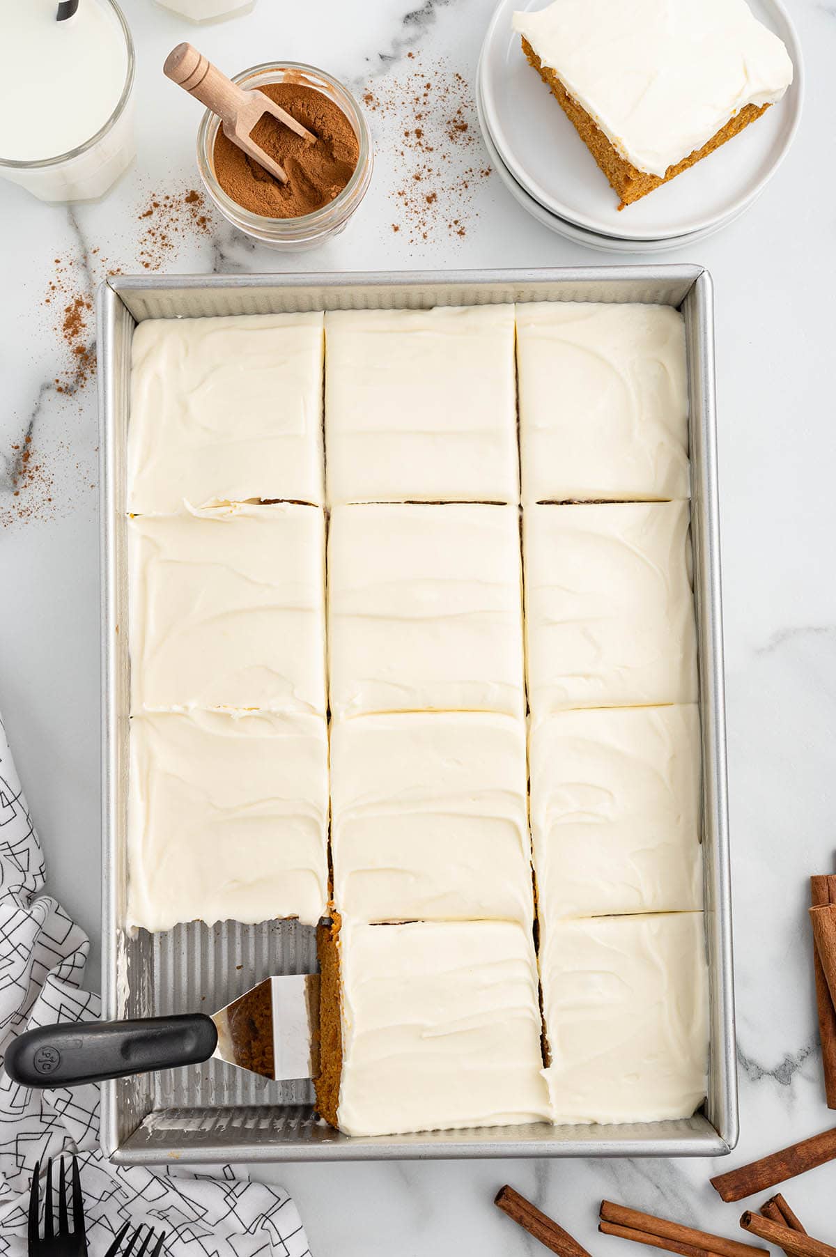 Pumpkin Bars in a baking pan cut into squares.