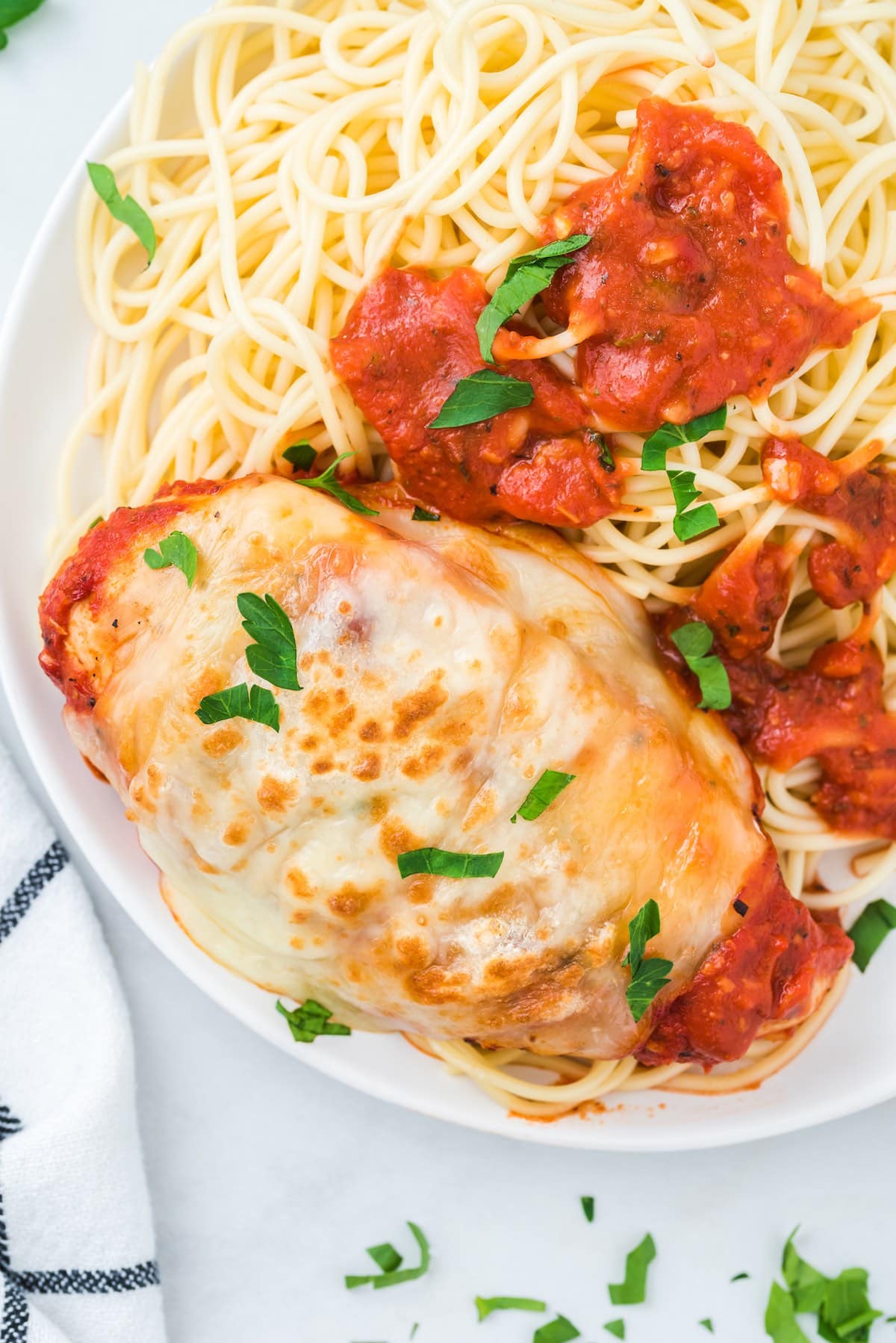 mozzarella chicken served over a spaghetti