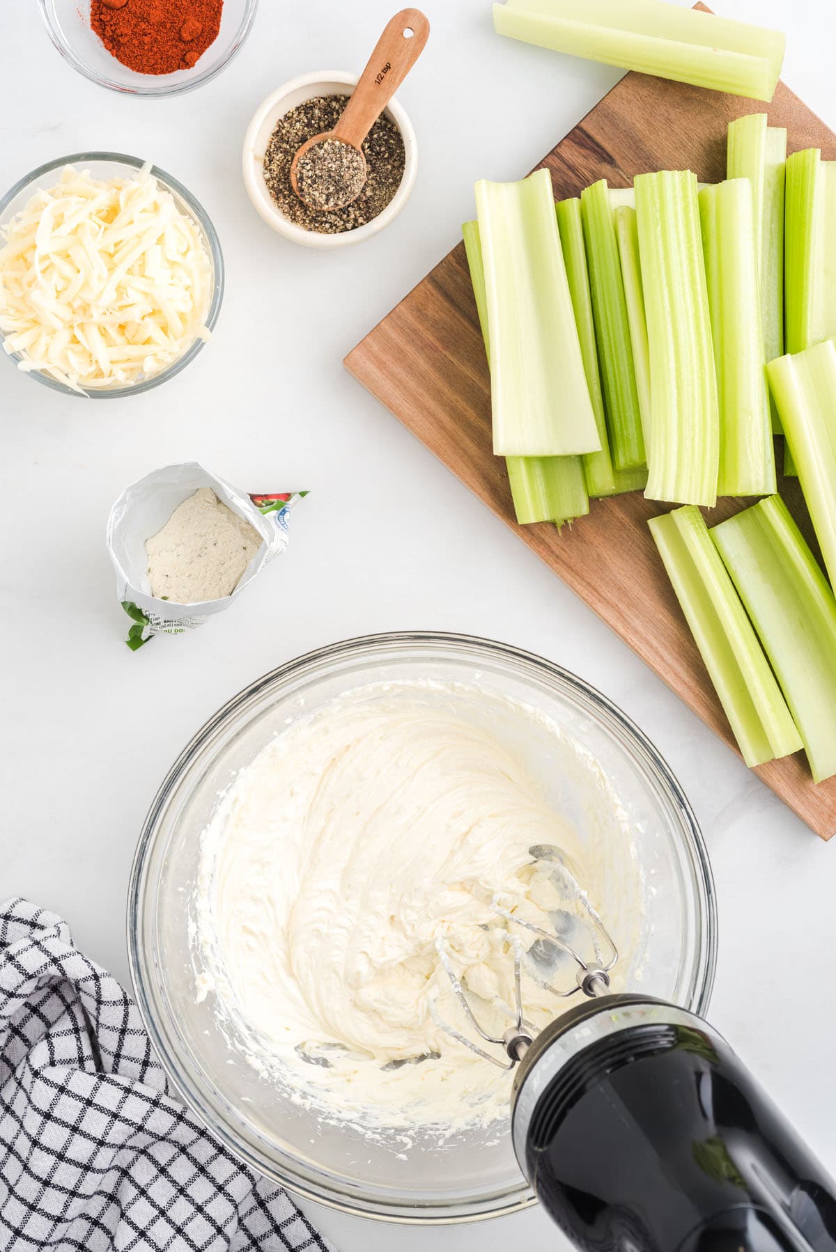 Beat together the cream cheese and mayonnaise with a mixer
