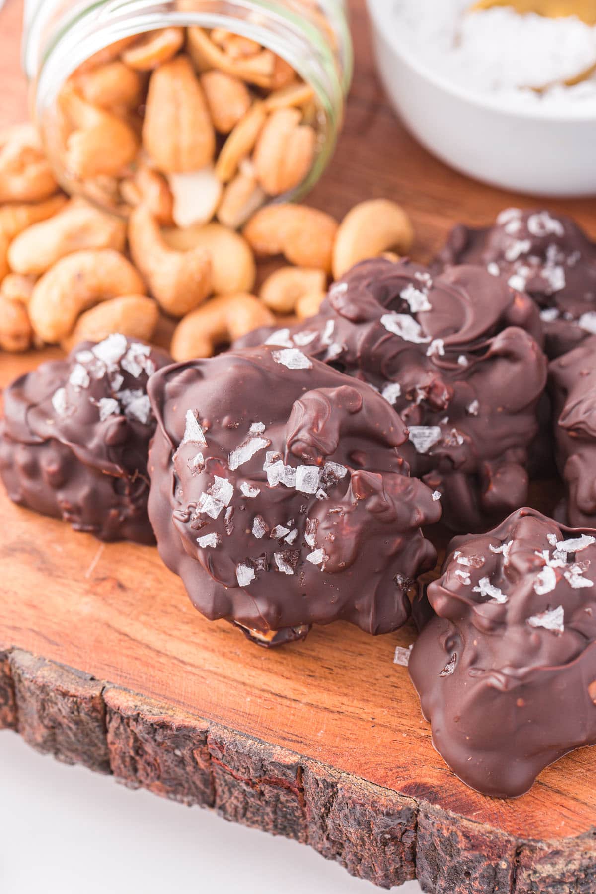 chocolate cashew clusters on wooden tray