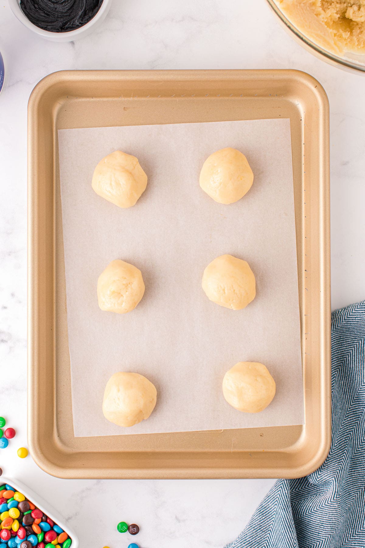 Roll dough into 2-inch balls and place on a lined baking sheet
