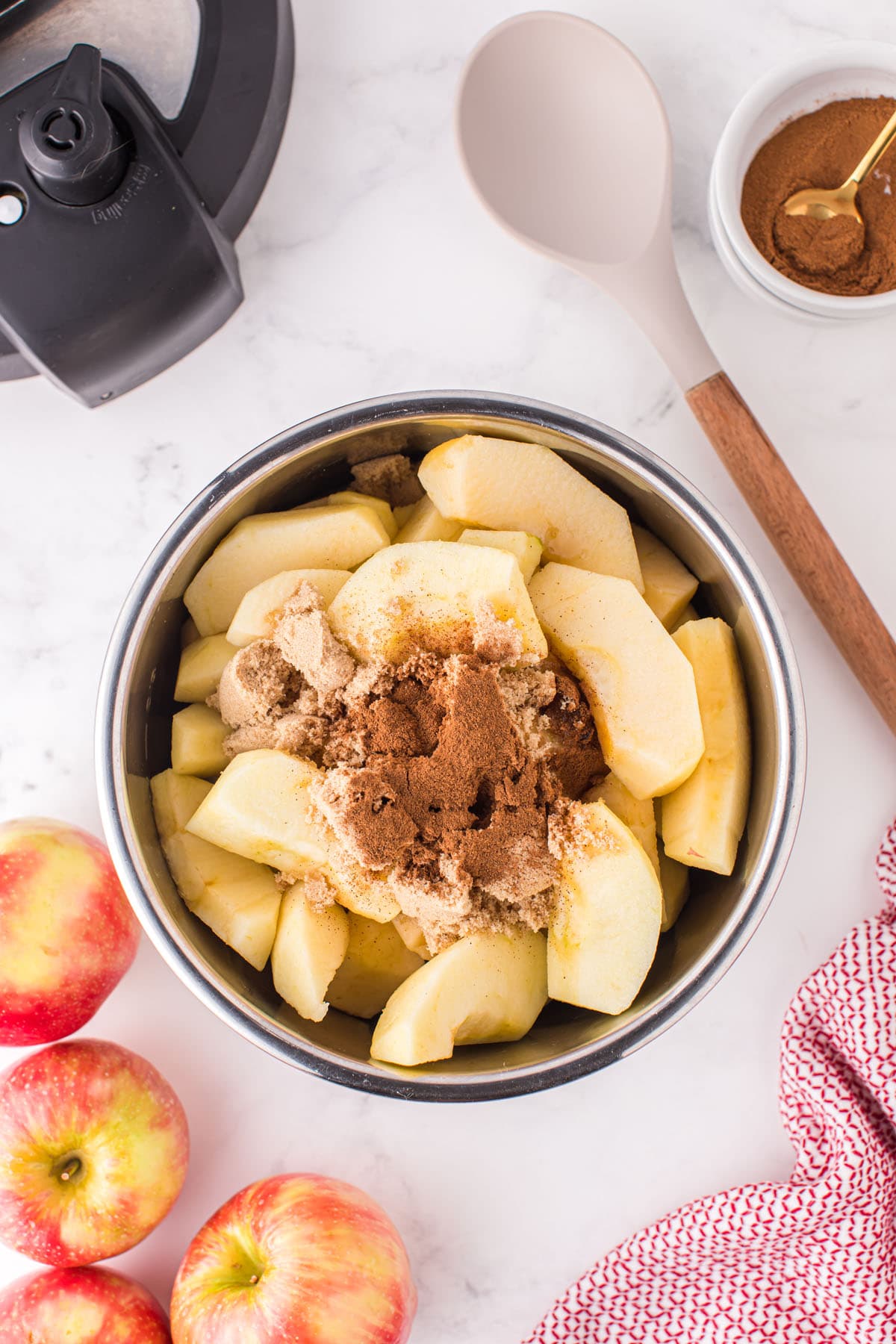 Add apples, water, sugar, and cinnamon to the pressure cooker