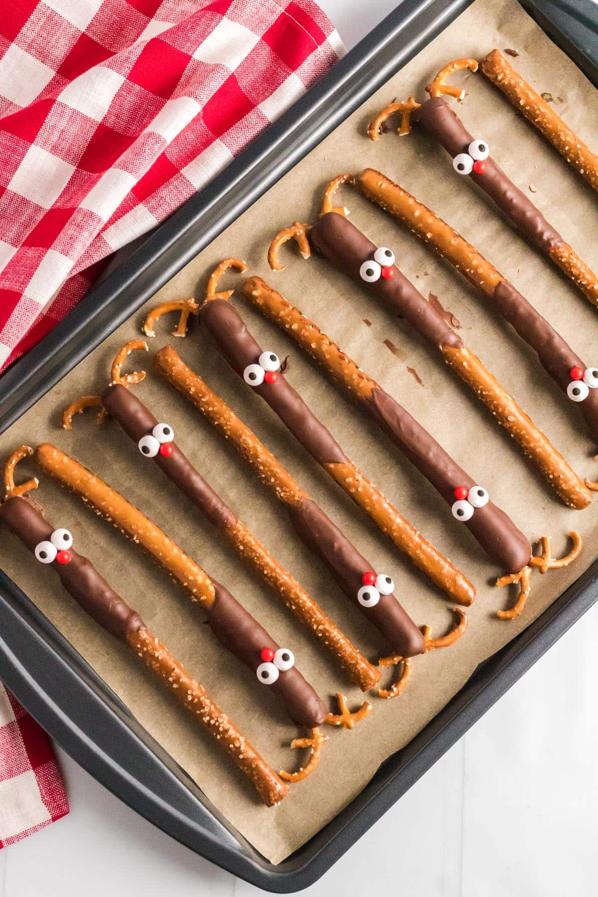 place the pretzel “antlers” into the chocolate.