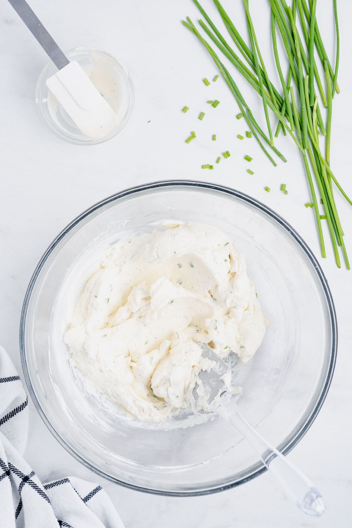 Cream together the cream cheese, ranch dressing, garlic powder, kosher salt, black pepper and chopped chives