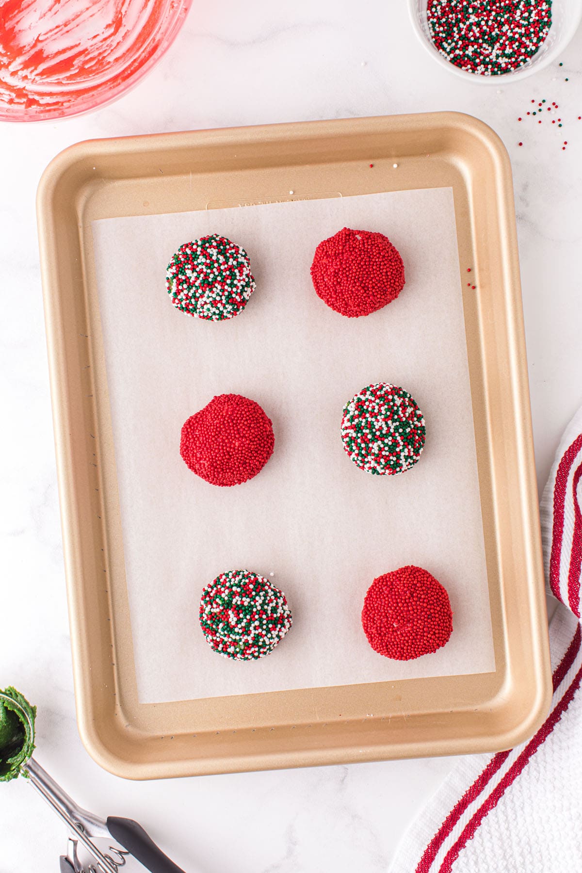 Place sprinkled covered dough balls on cookie sheet