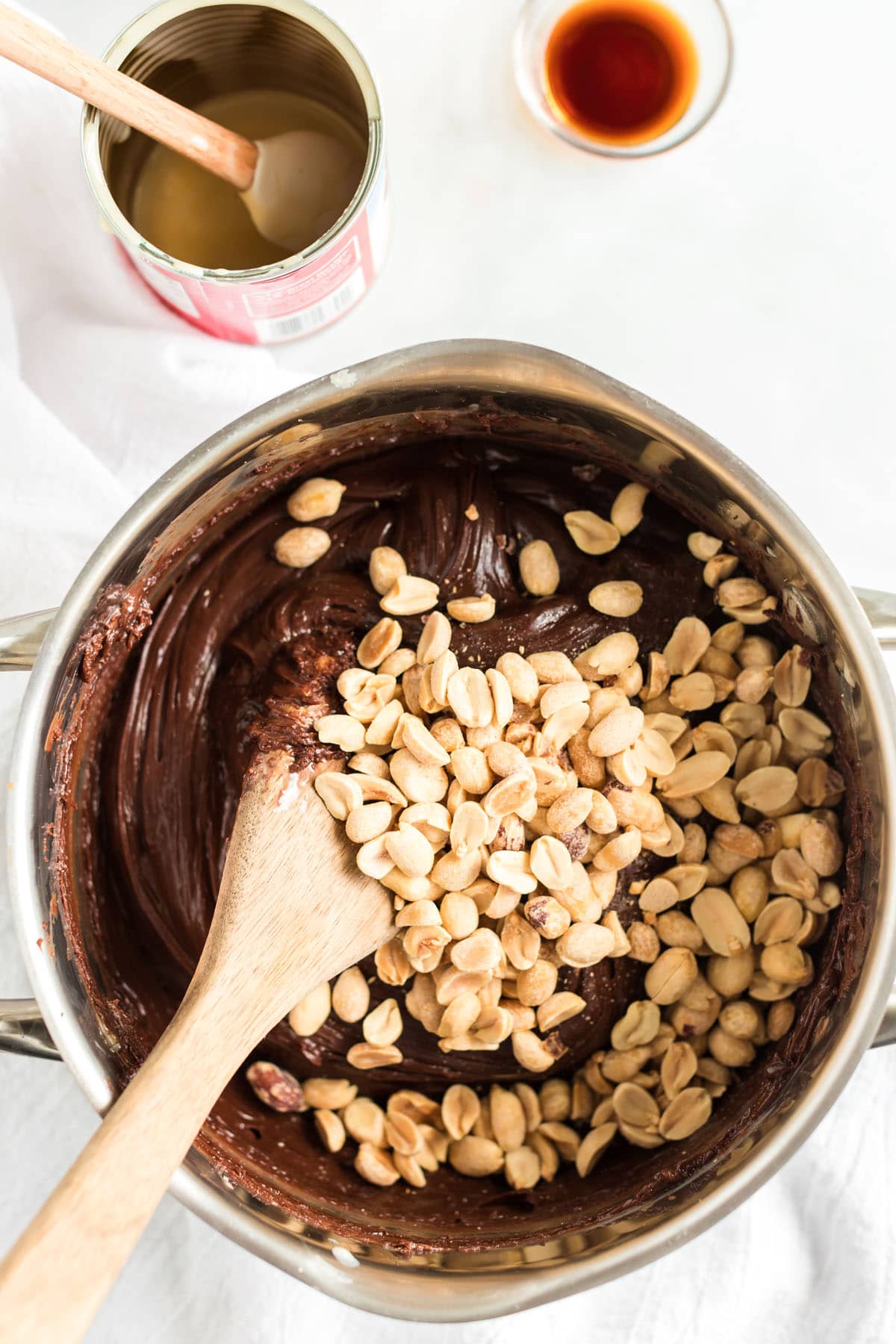 add peanuts to the melted the chocolate chips, sweetened condensed milk and butter