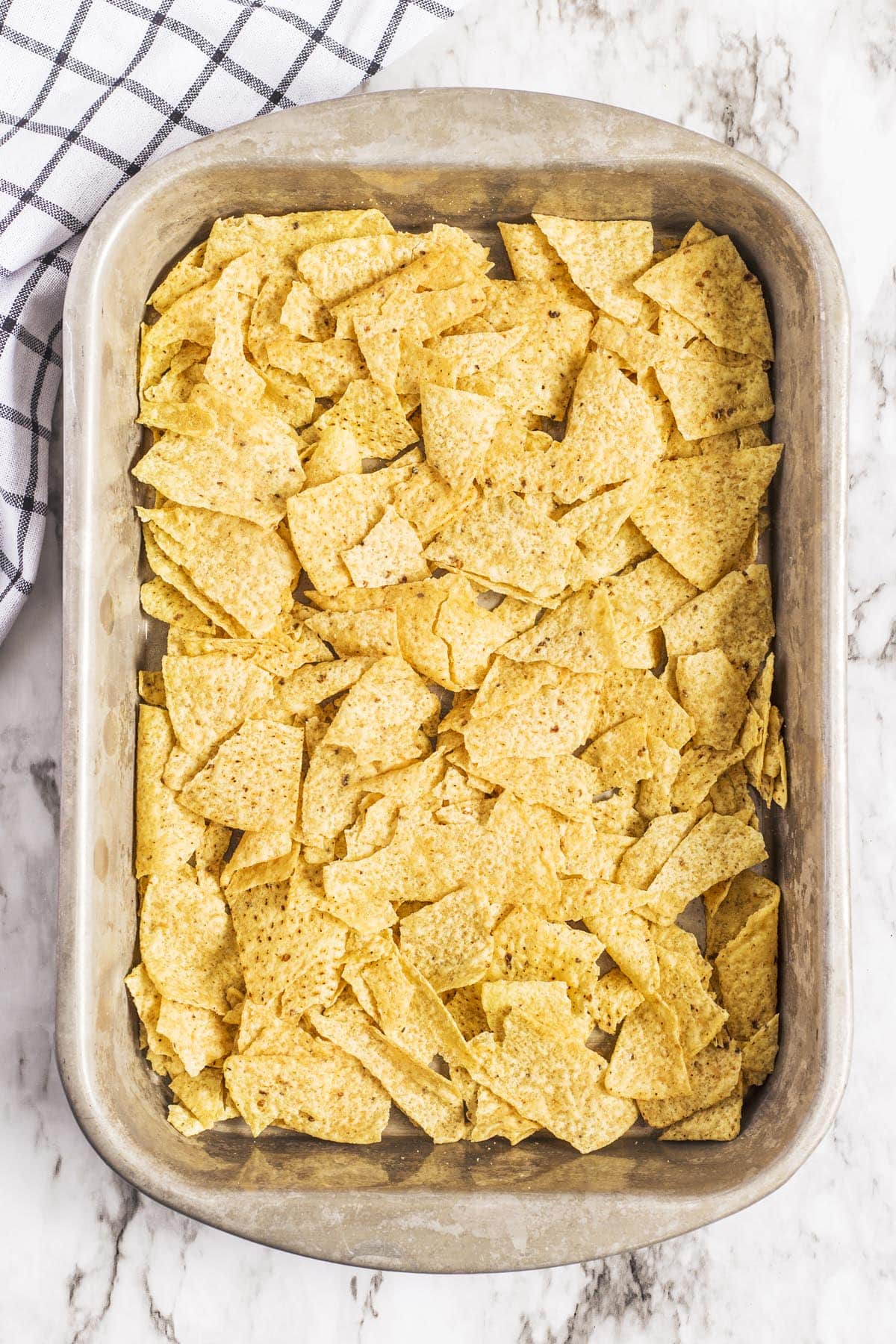 Fill the bottom of a prepared pan with corn chips