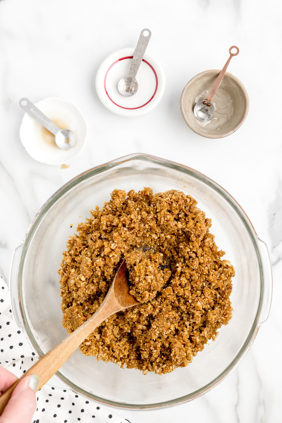 Mix together chopped pecans, graham cracker crumbs, brown sugar, maple syrup, karo syrup, melted butter, almond and rum extracts
