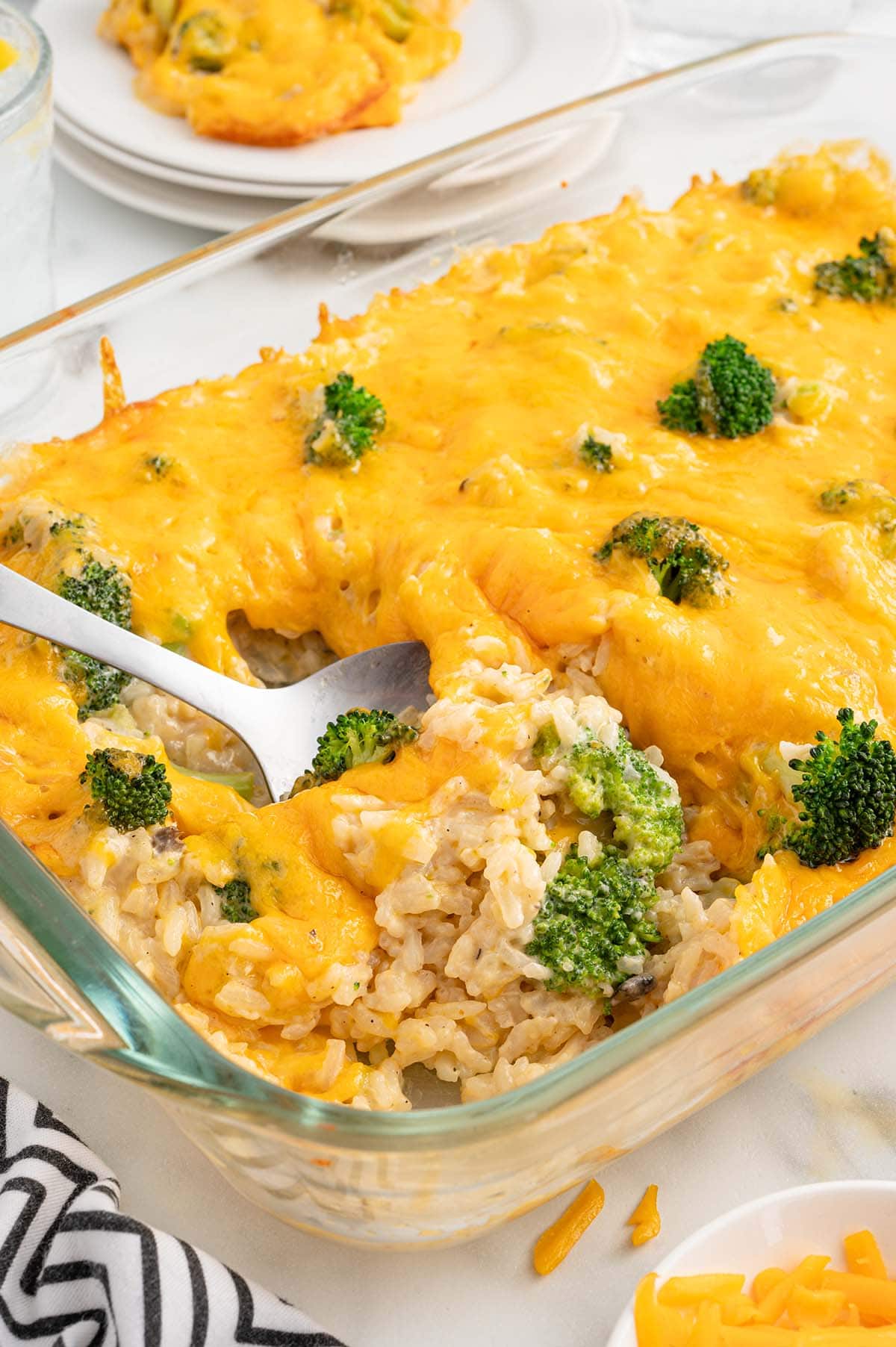 Broccoli and Rice Casserole in a casserole dish with melted cheddar cheese on top.