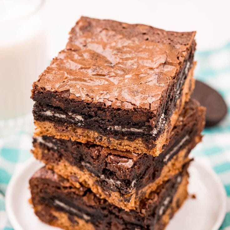 slutty brownies stacked on top of a plate.