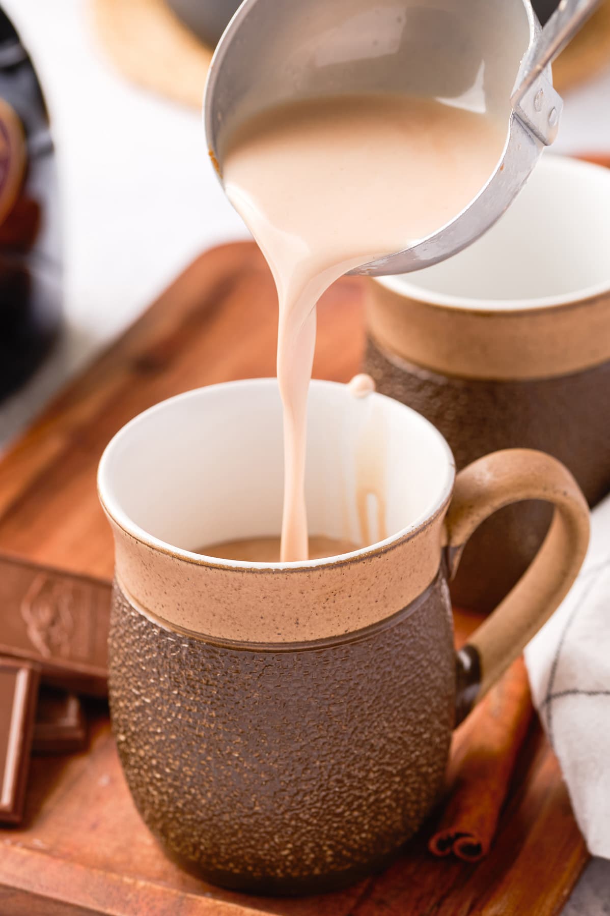 pouring hot chocolate into the mug