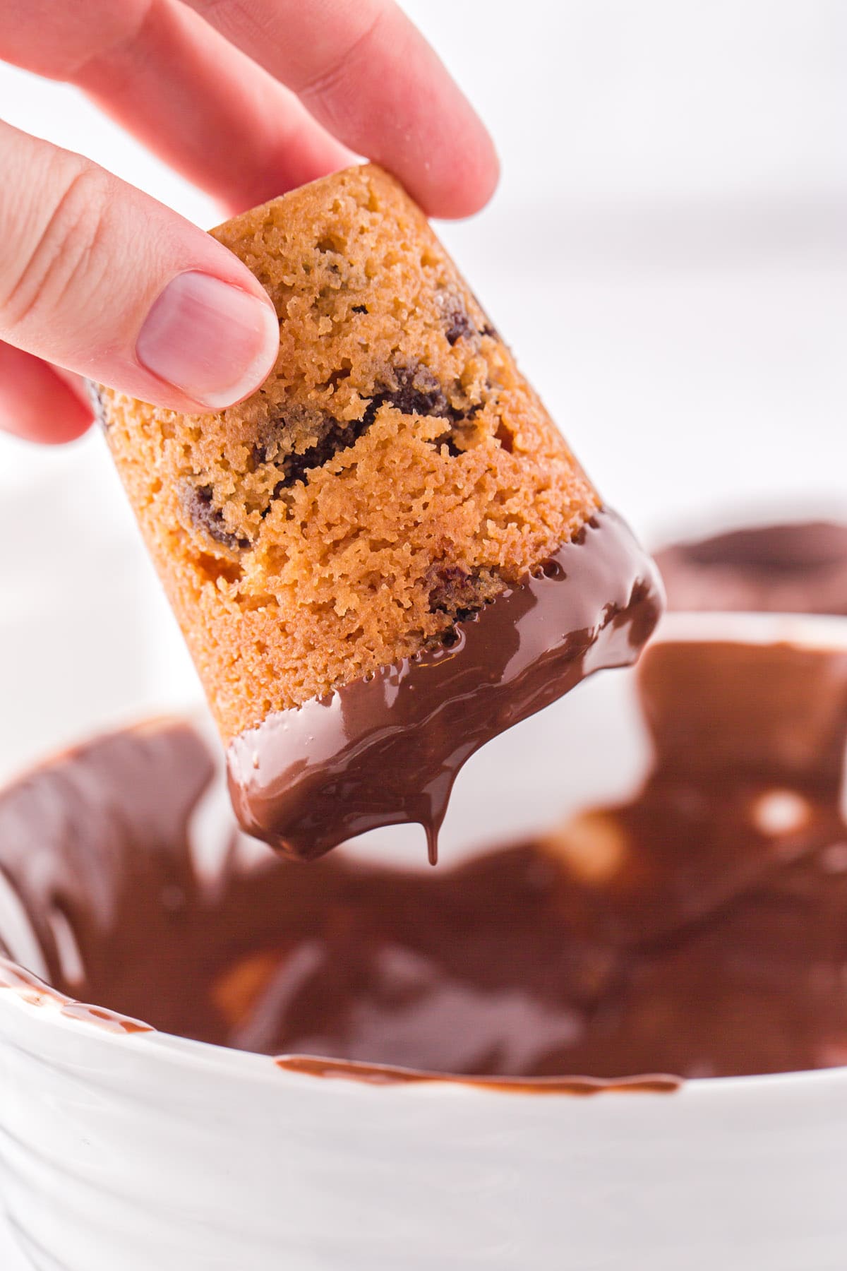 dip the rim cookie shooters into the chocolate
