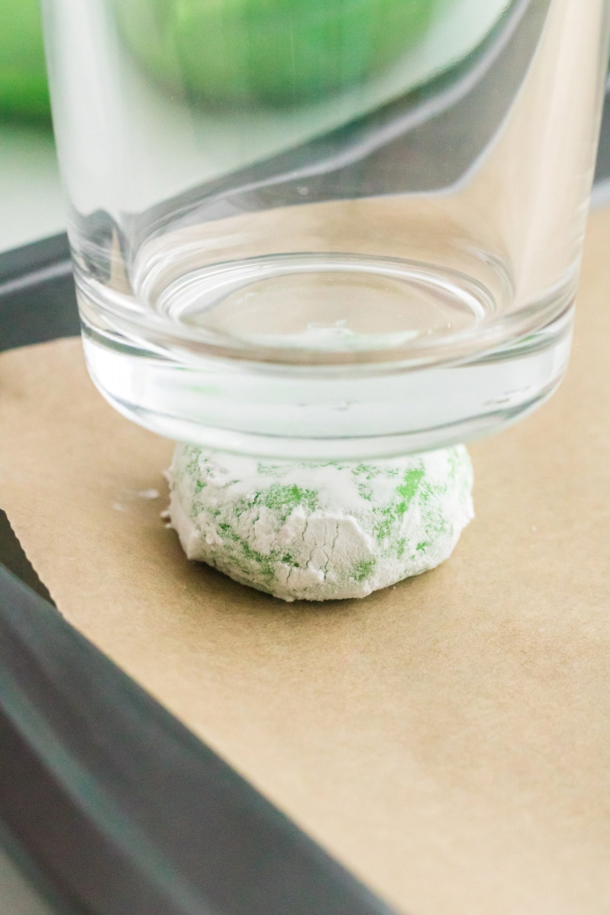 press down cookie dough using glass bottom