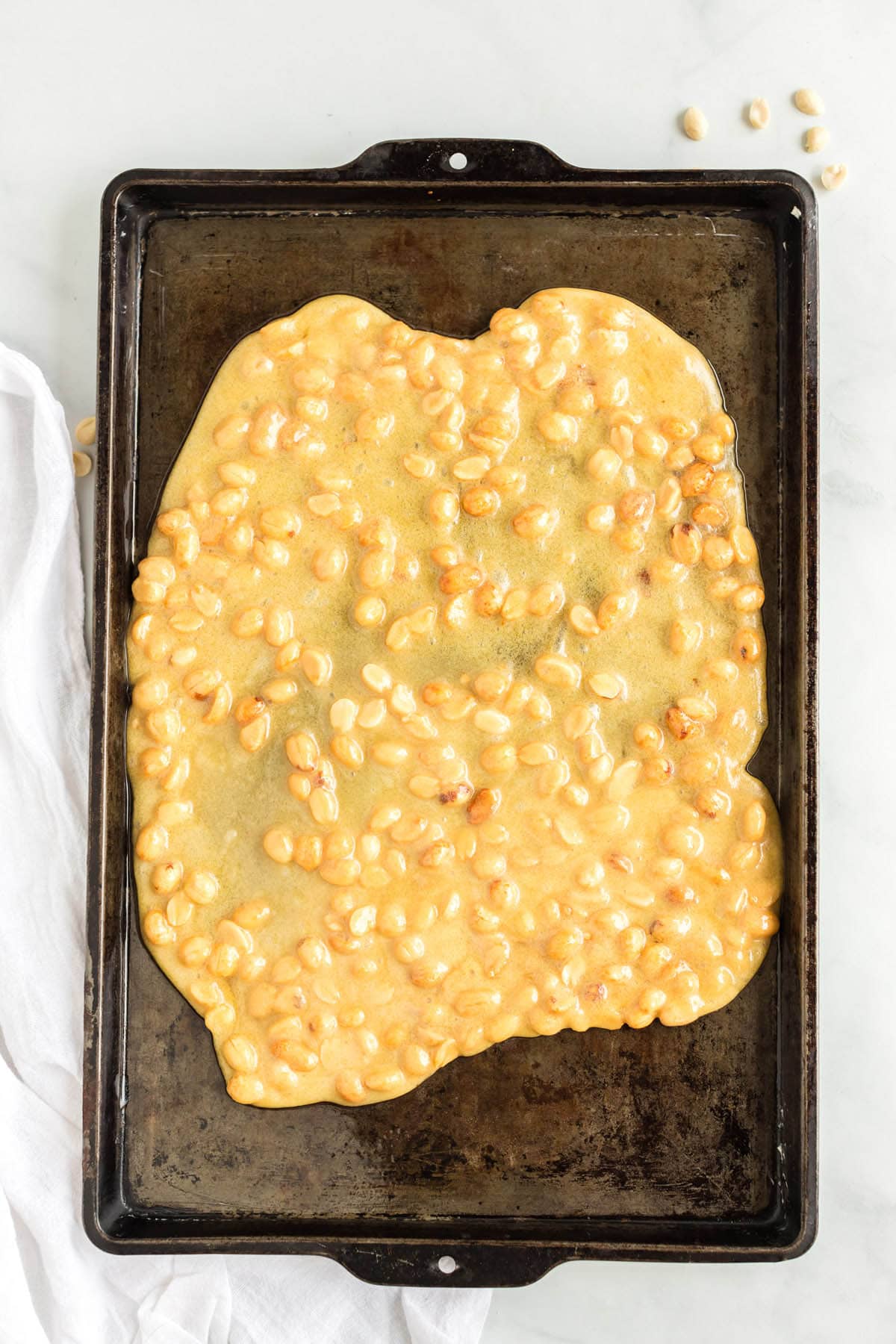 spread the peanut brittle mixture into cookie sheet