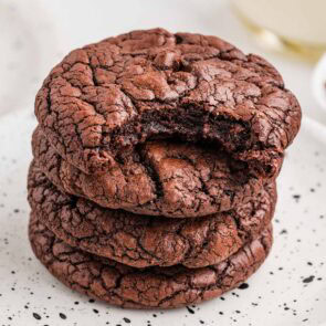 brownie cookies stacked with one bitten piece on top.