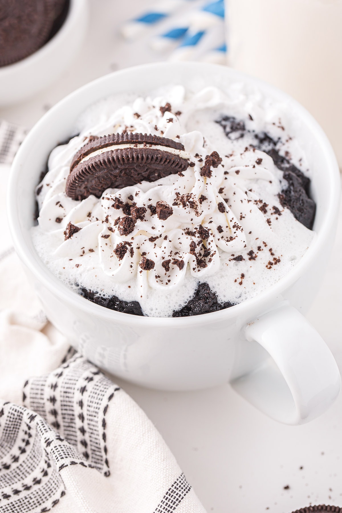 A cup of coffee, with Oreo and Cake