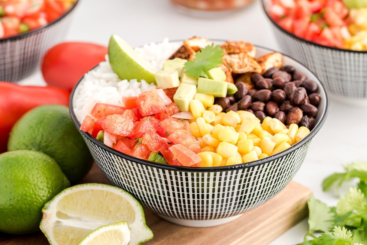 A bowl of fruit on a plate, with Burrito bowl