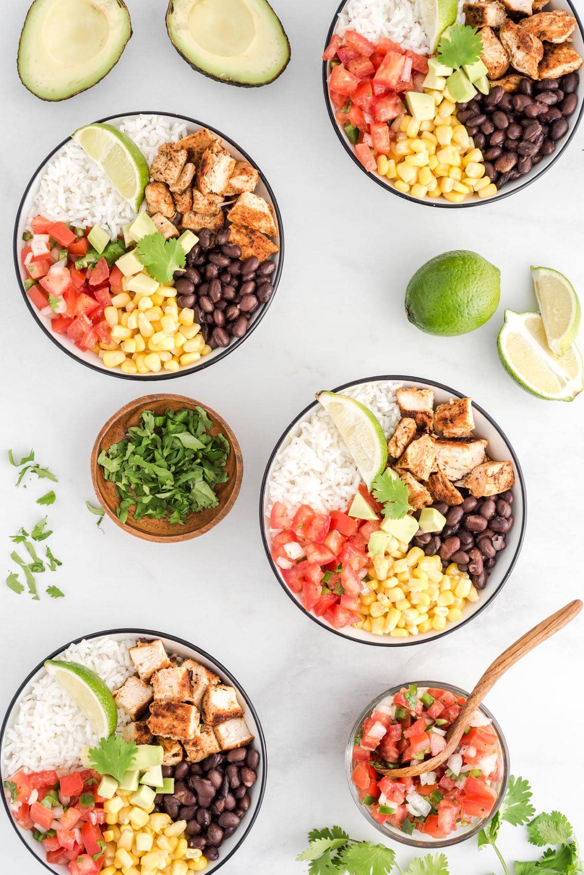 A table full of different types of food on a plate, with Burrito bowl