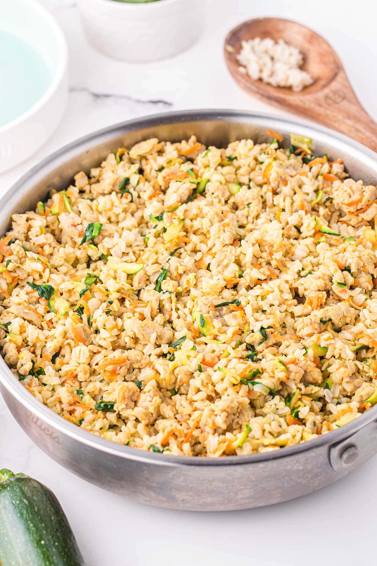 Skillet of homemade dog food with turkey, rice, and vegetables.