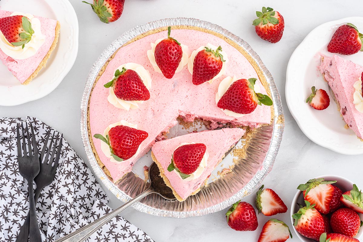 strawberry cool whip pie cut into slices