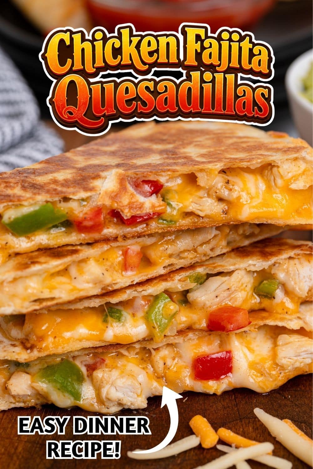 Stacked chicken fajita quesadilla wedges with melted cheese, peppers, and chicken on a wooden board.