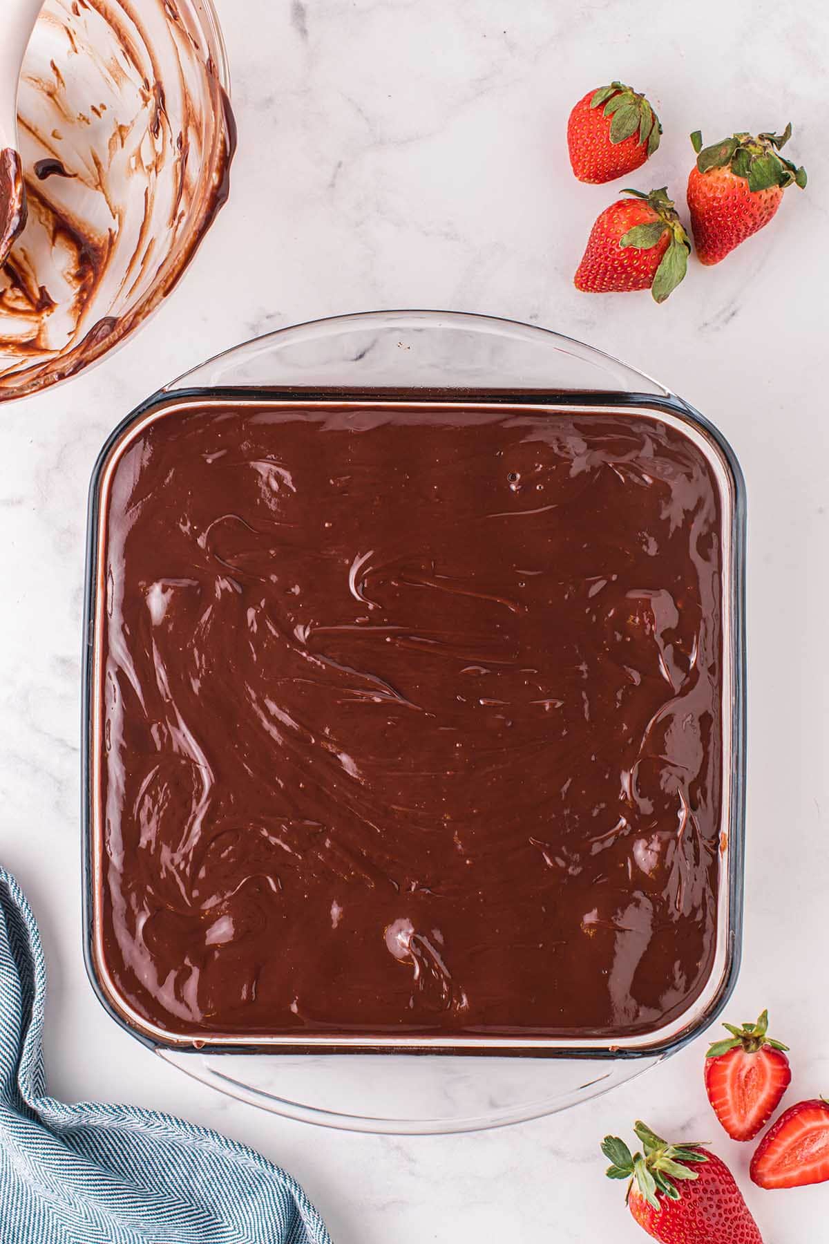 pour ganache on top of the strawberries