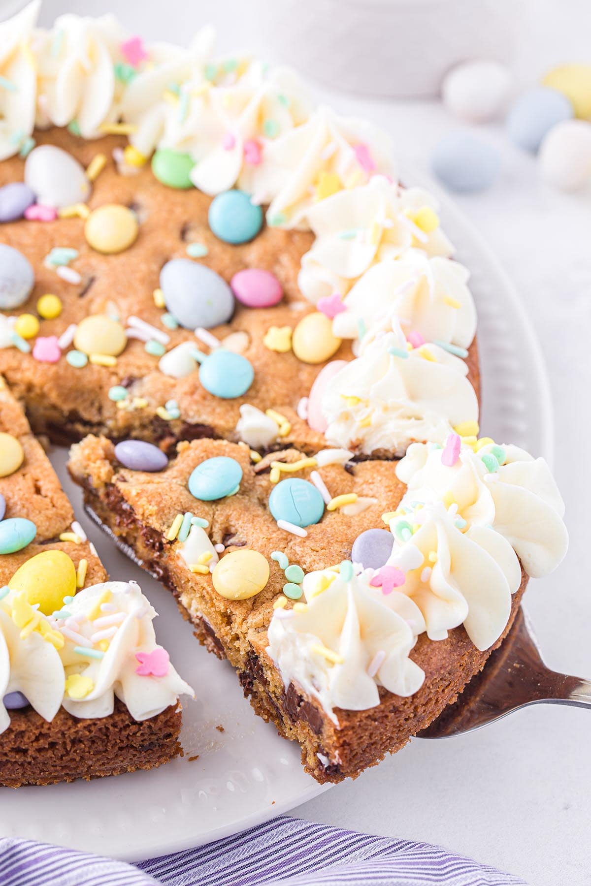 cutting a slice of easter cookie cake