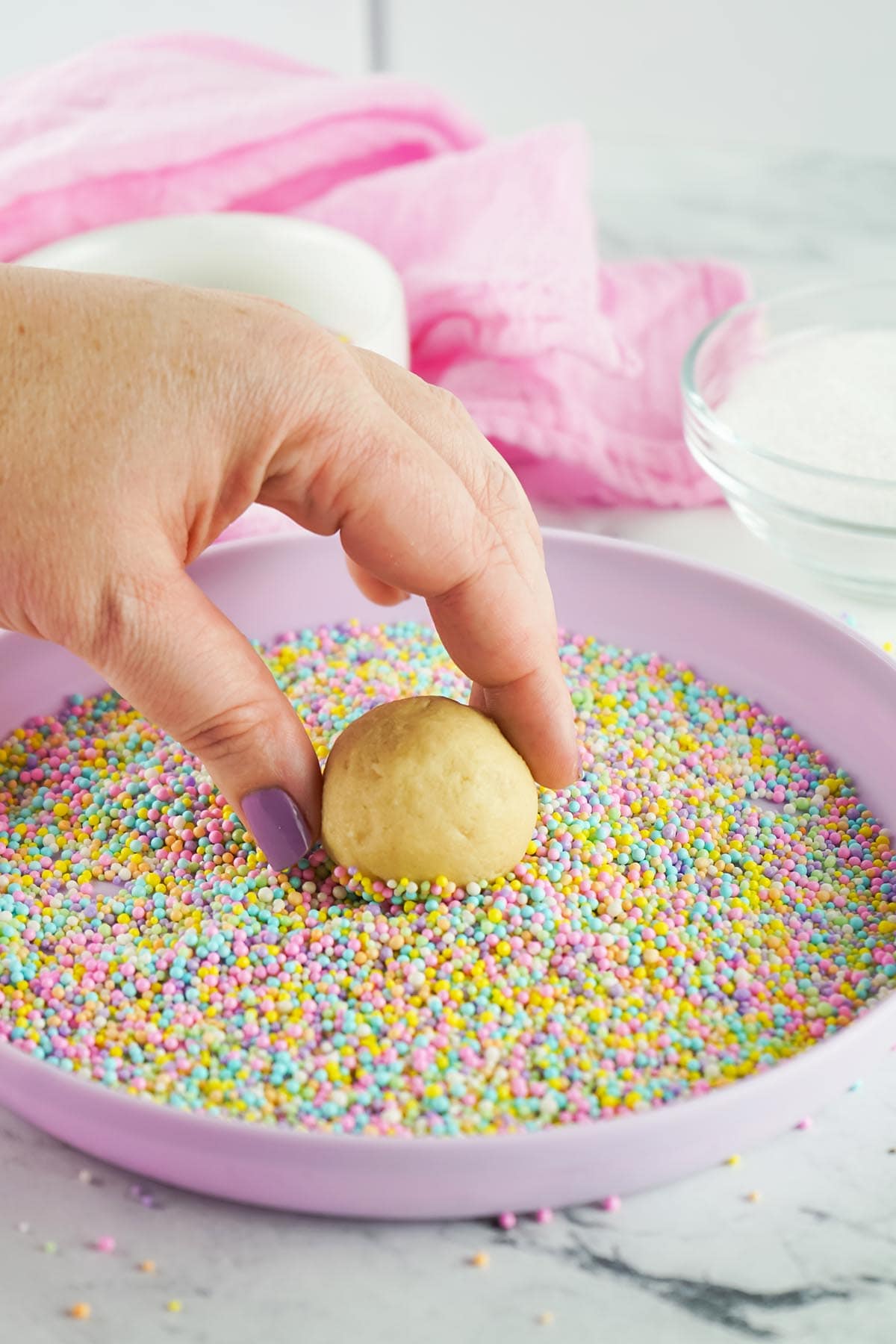 roll dough ball in sprinkles