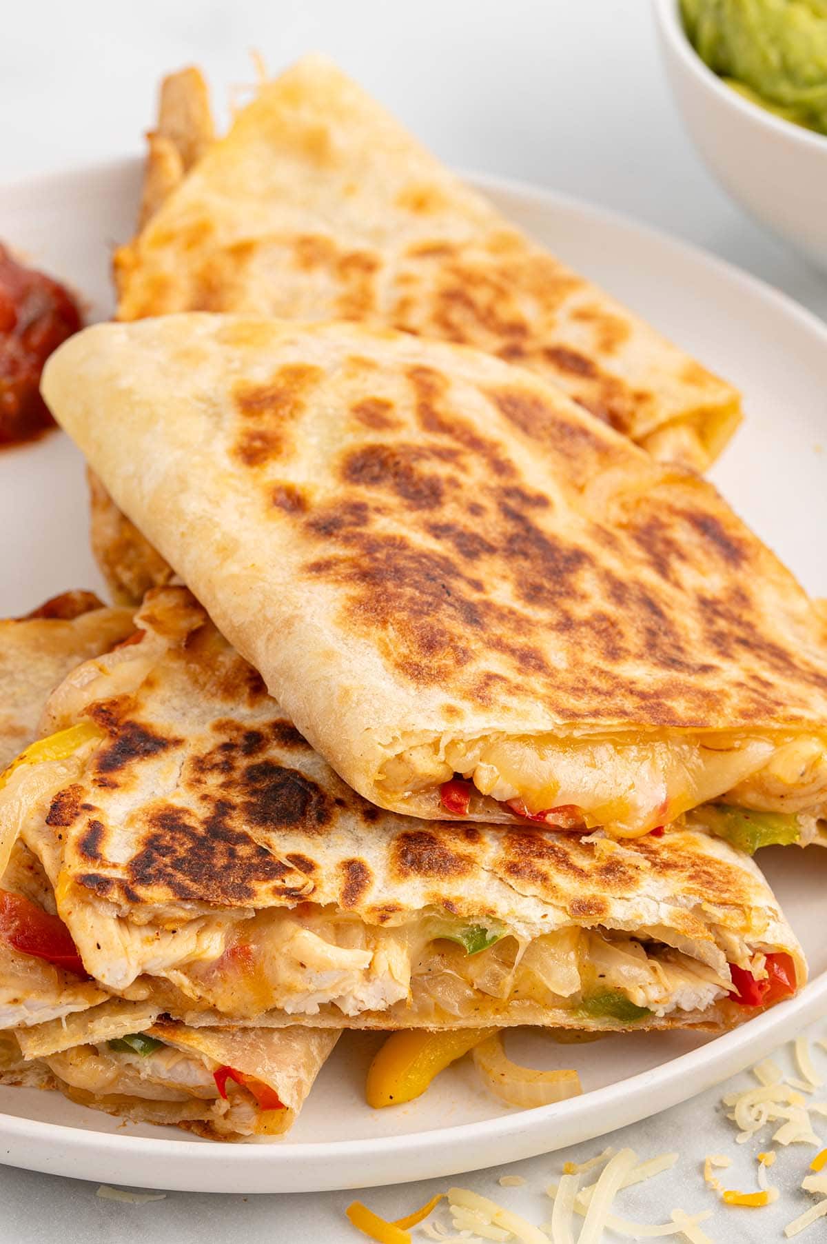 a white plate full of fajita quesadilla.