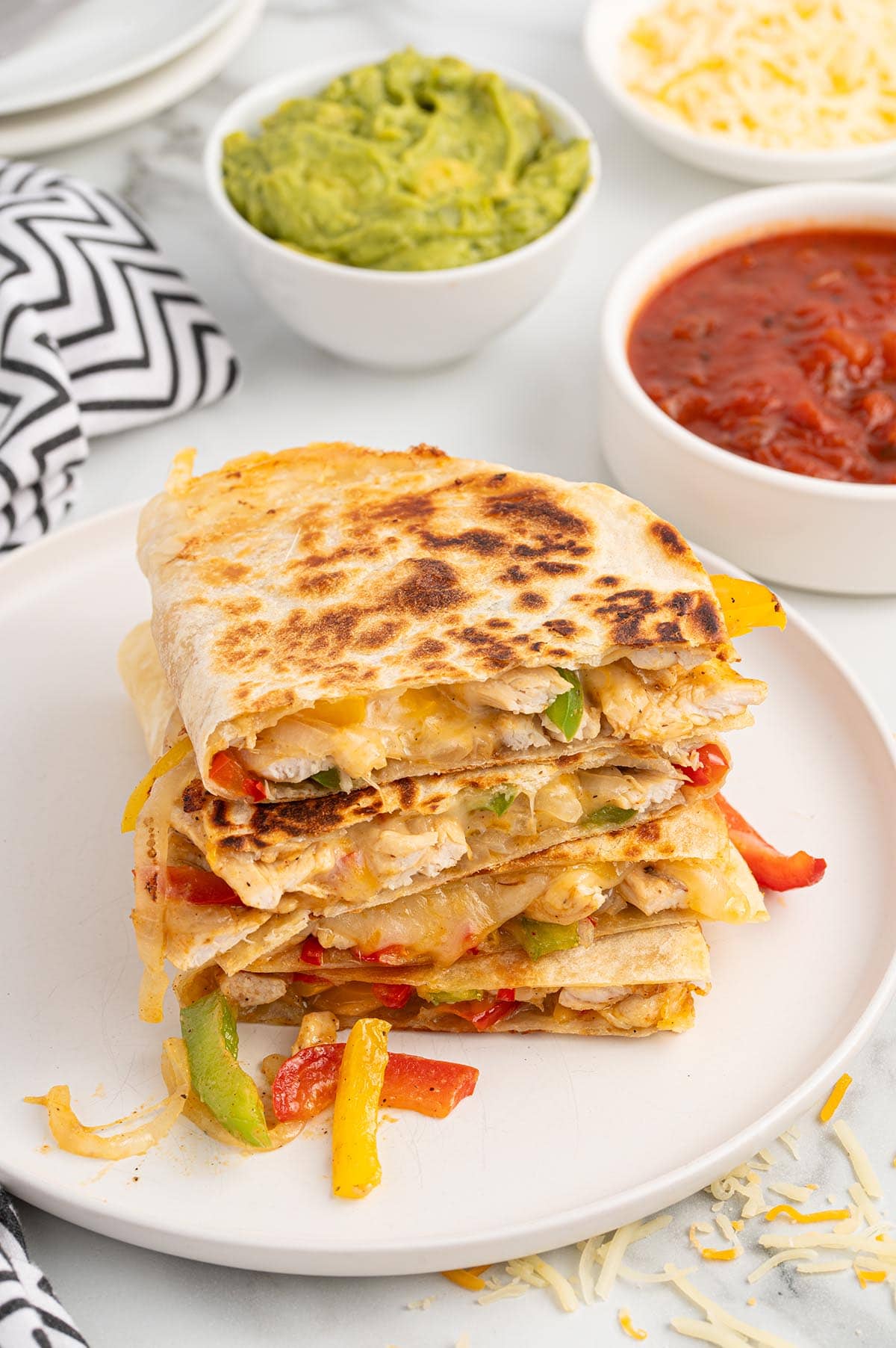 Stack of fajita quesadilla on a plate.