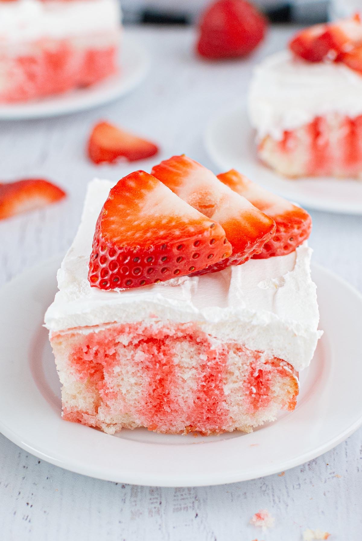 a slice of jello poke cake on a plate. 