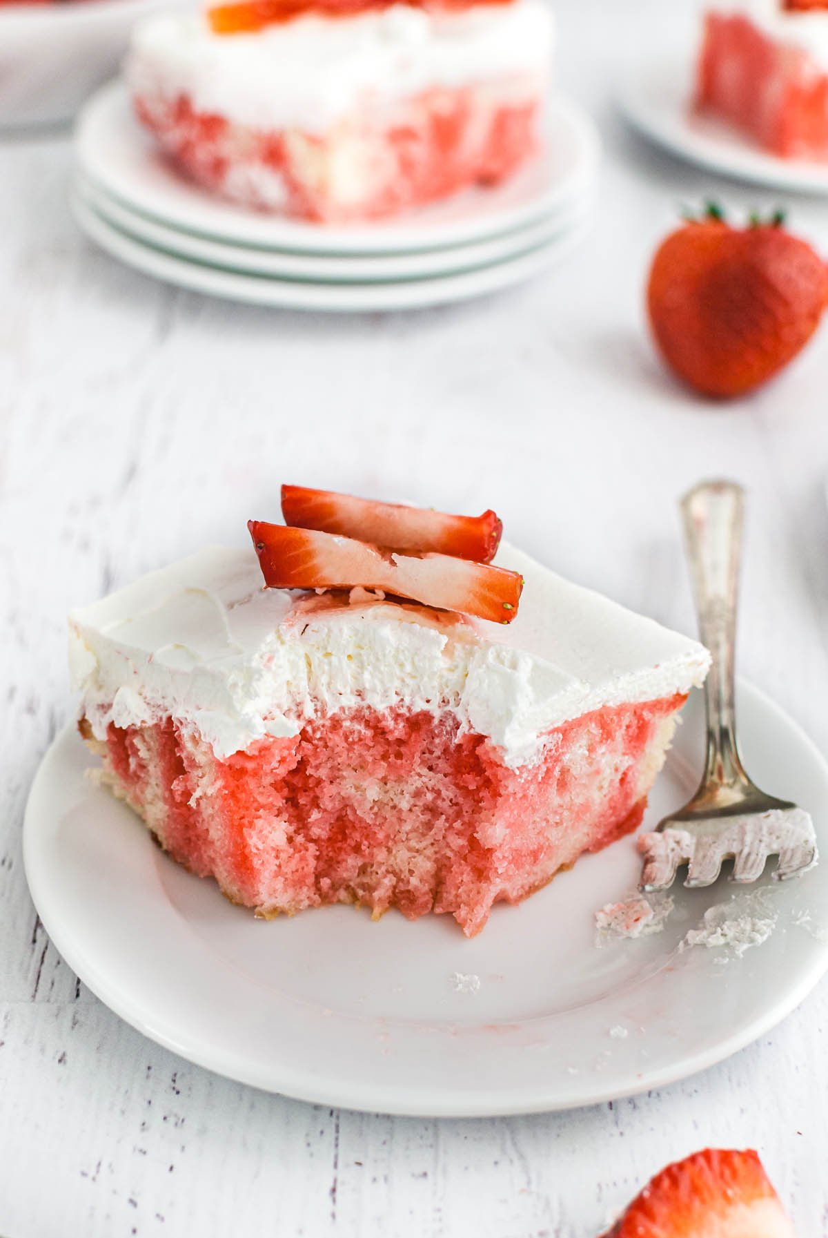 a slice of jello poke cake on a white plate