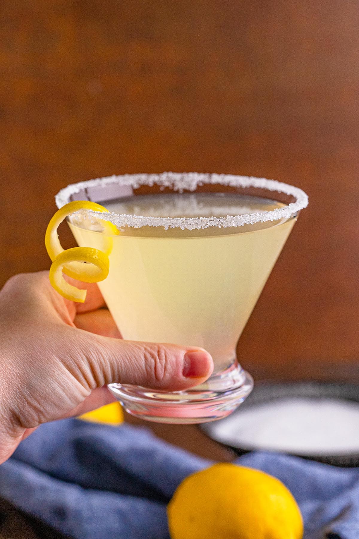 hand holding lemon drop martini