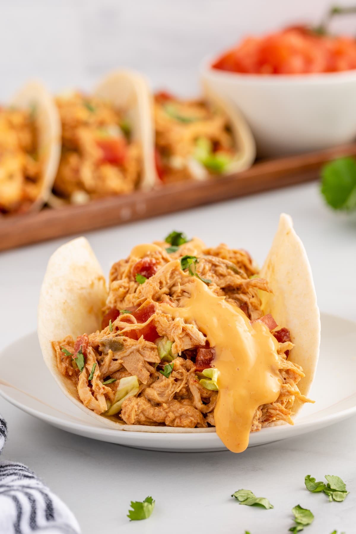 slow cooker queso chicken tacos on a plate