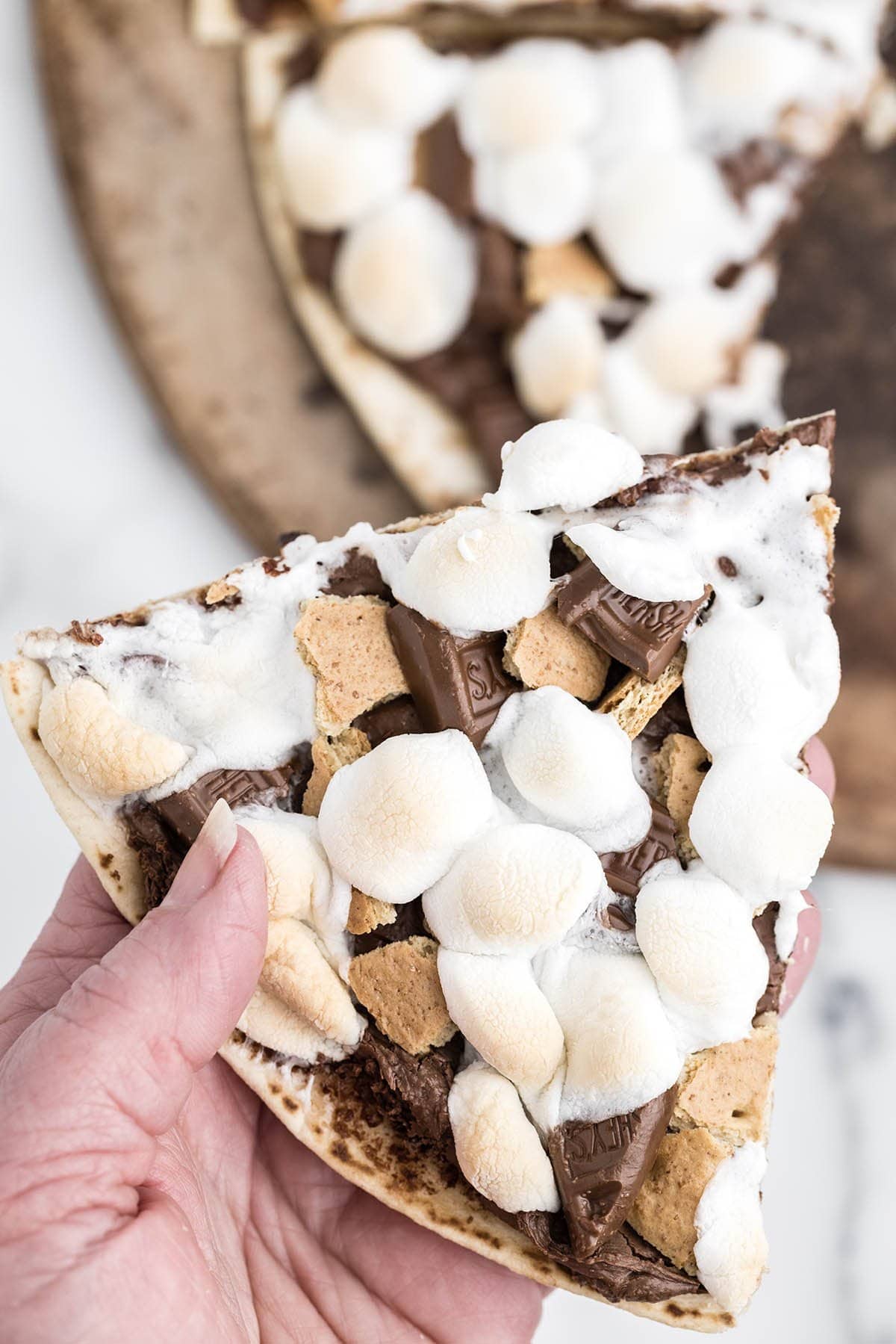 hand holding smores pizza