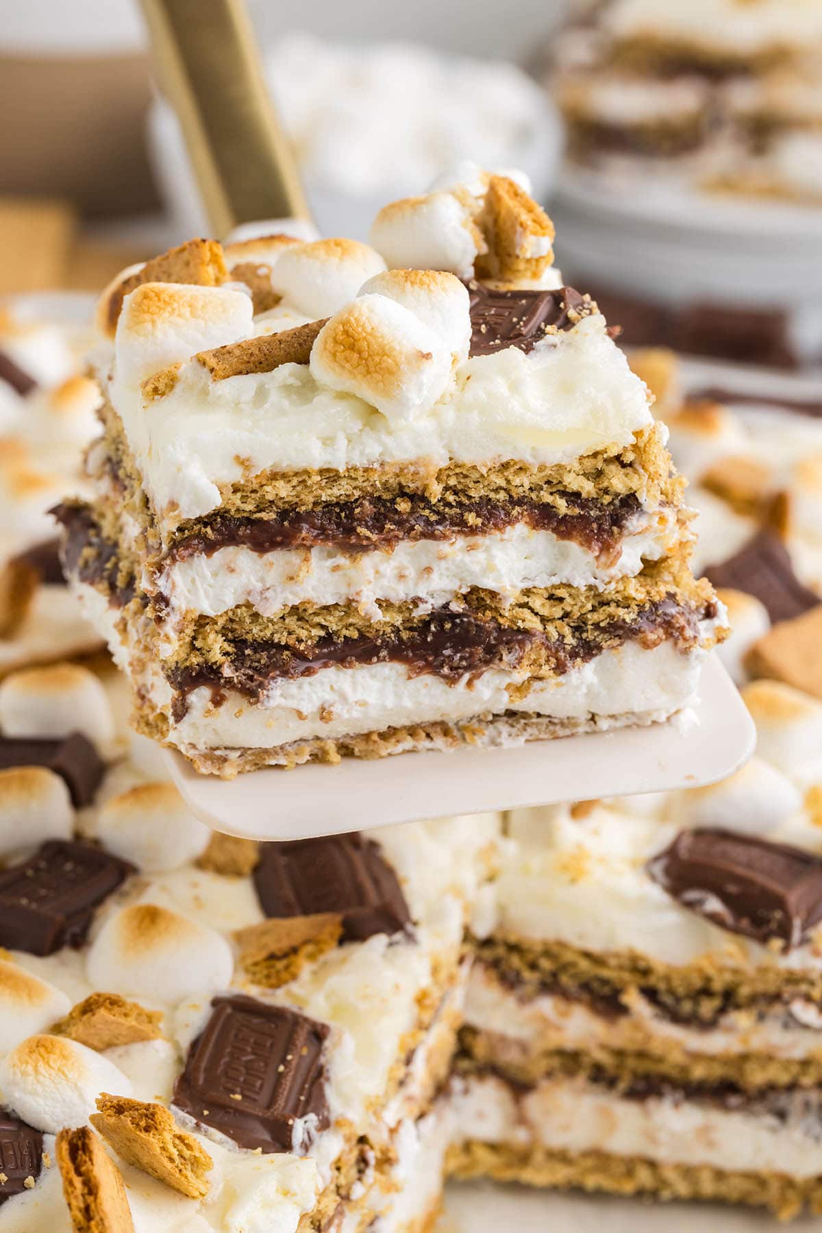 cutting and serving a slice of smores icebox cake.