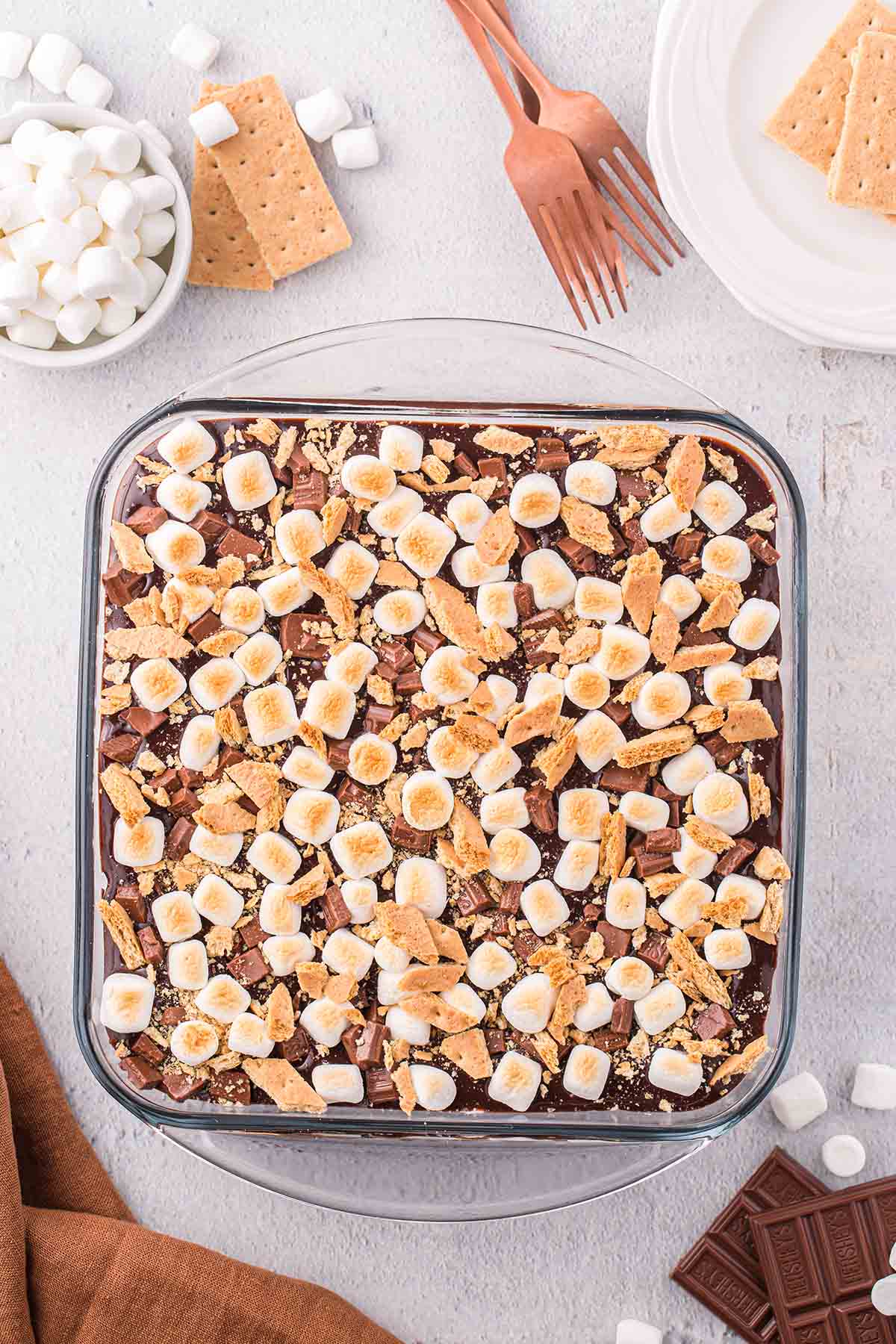 smores cheesecake in a square baking pan