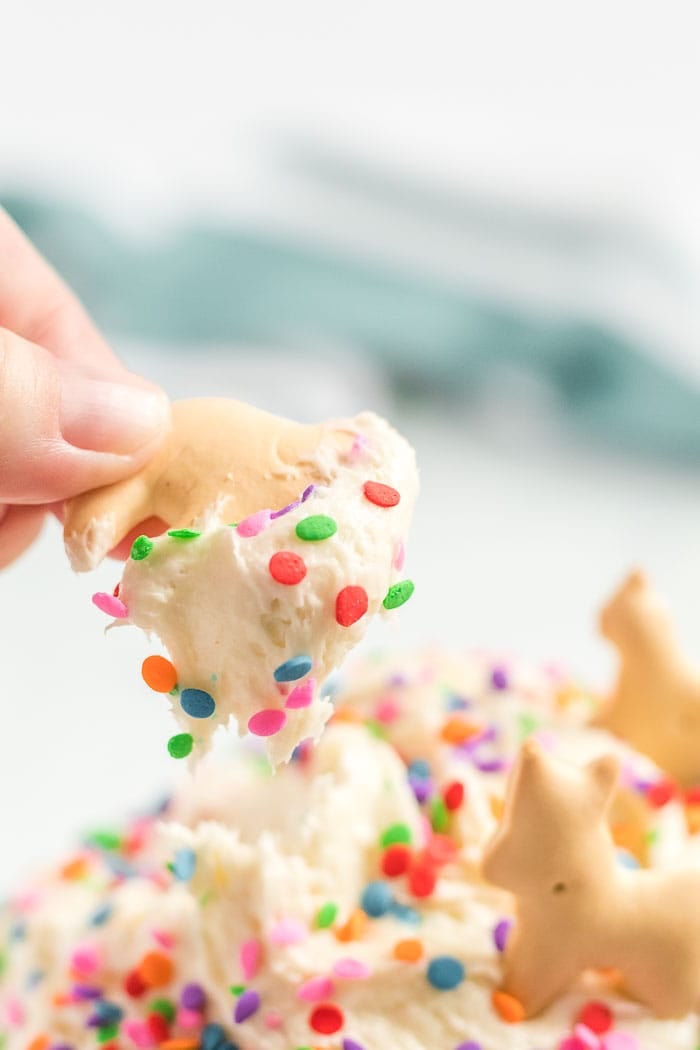 dipping cracker into the funfetti dip