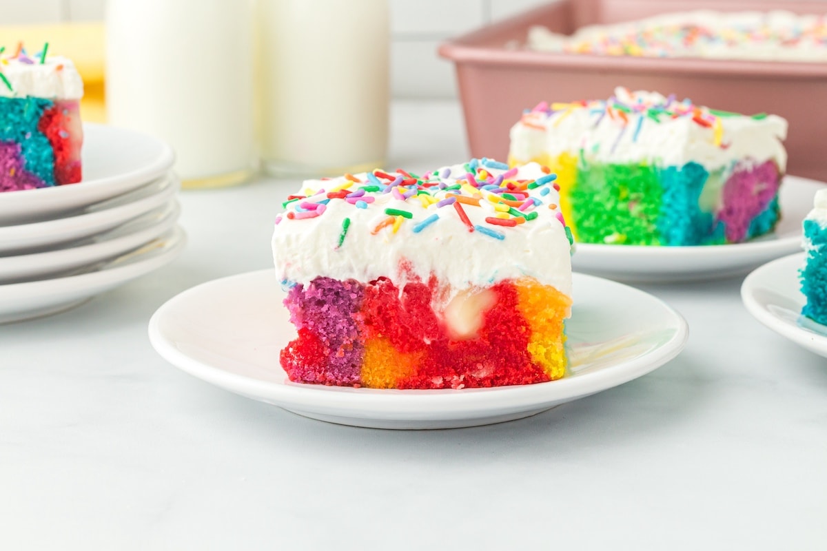 rainbow poke cake on a plate