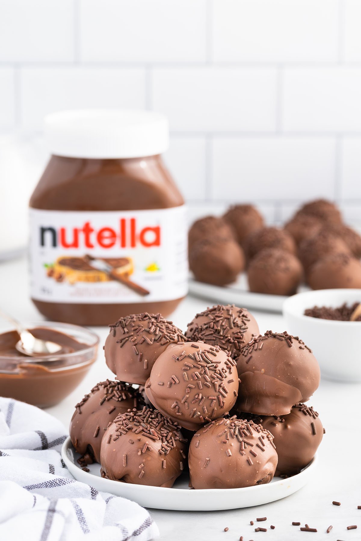 nutella truffles stacked on a white plate
