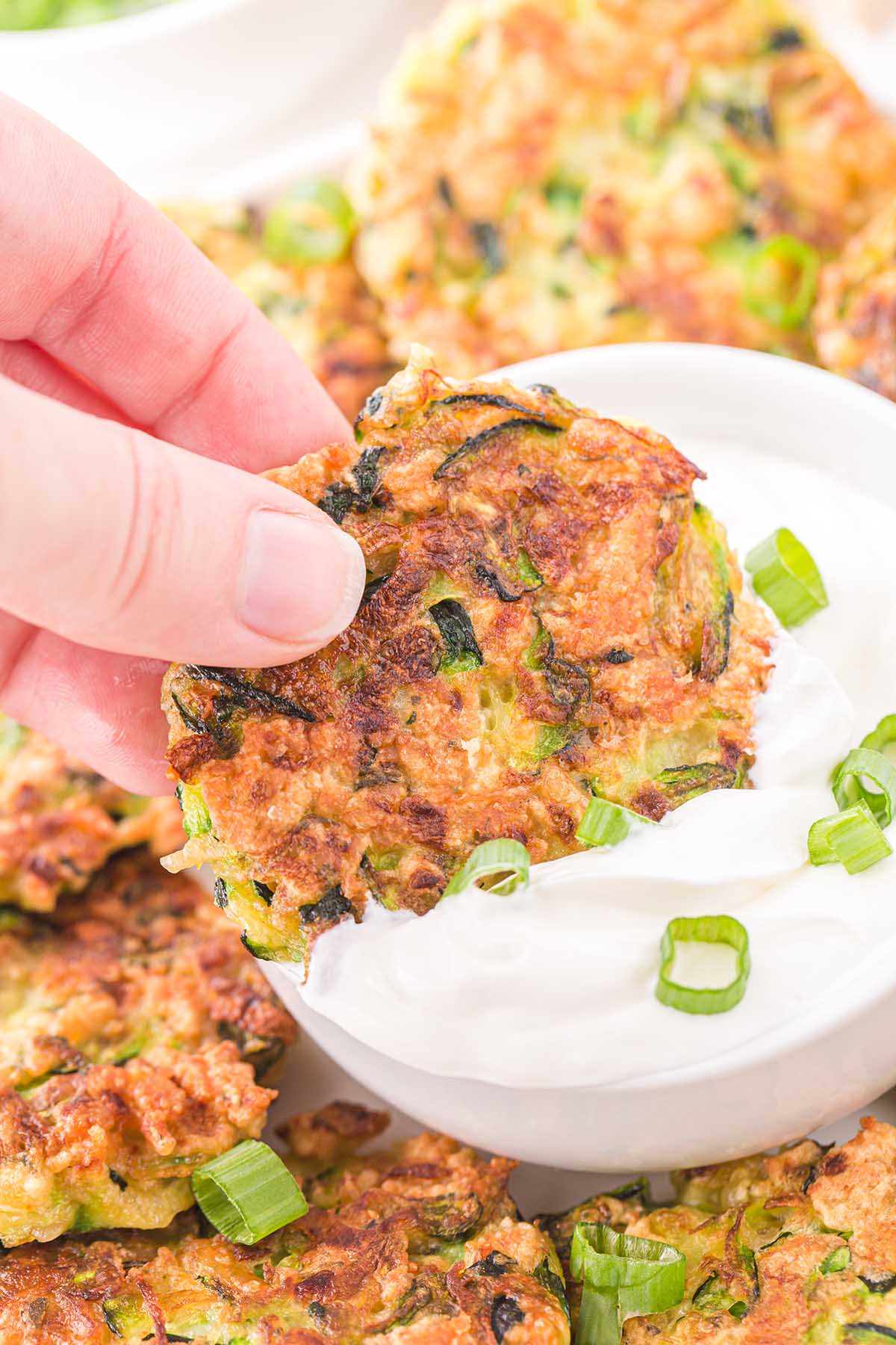dipping zucchini fritters to sour cream
