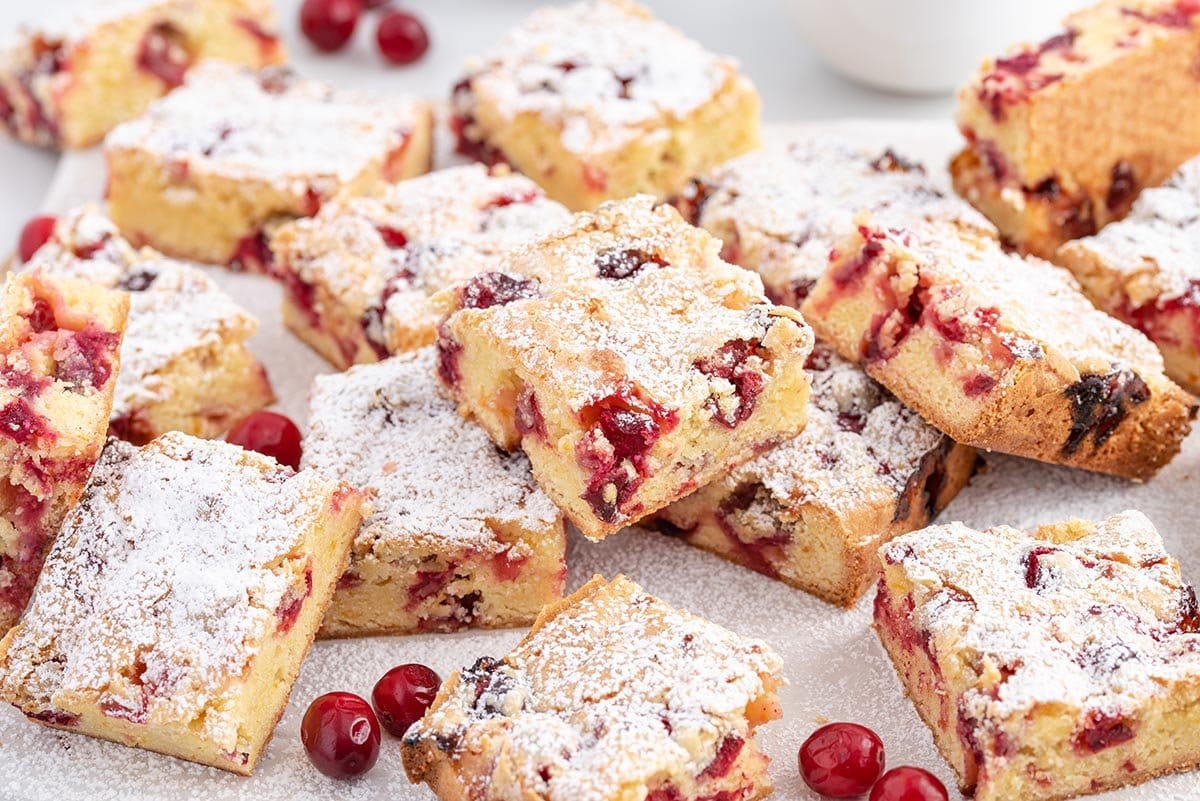 cranberry cake squares with powdered sugar on top