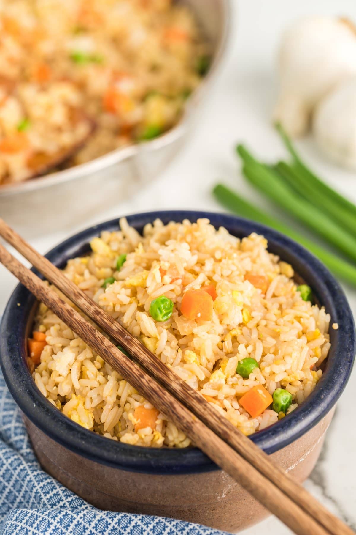 fried rice in a bowl with chopsticks