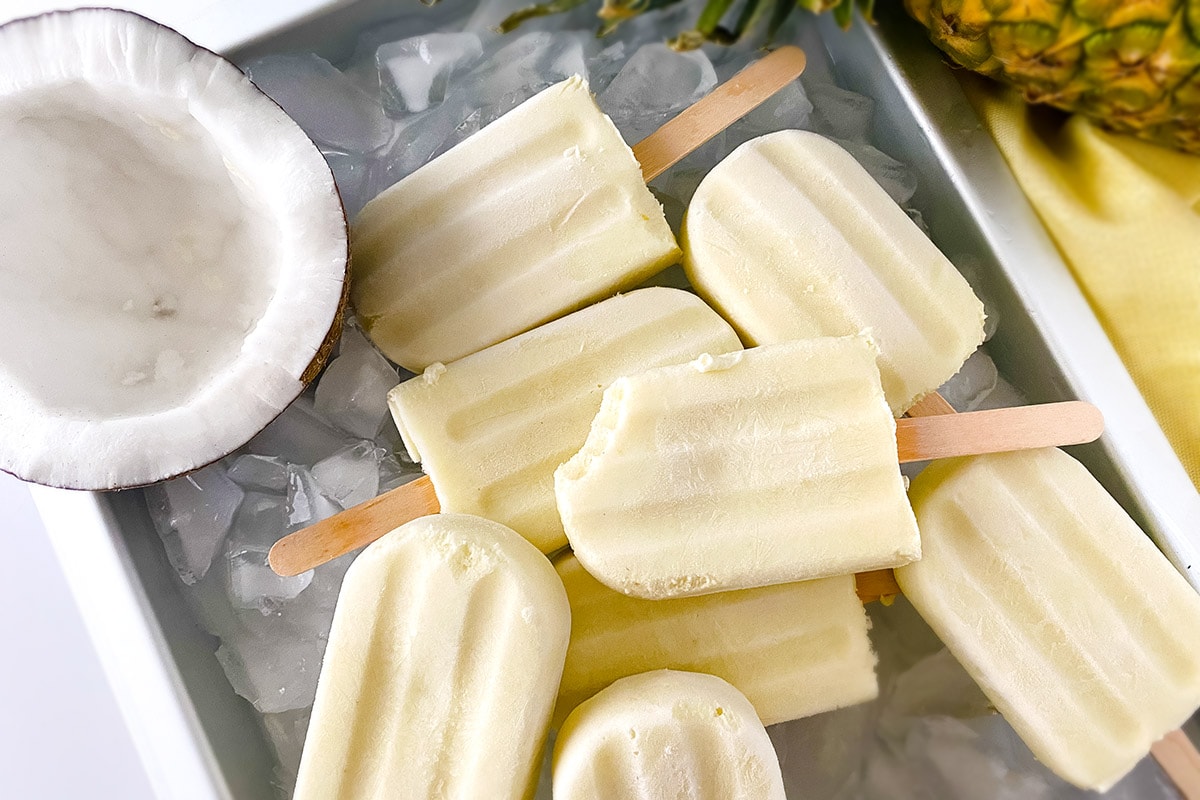 pina colada popsicle on a tray with ice