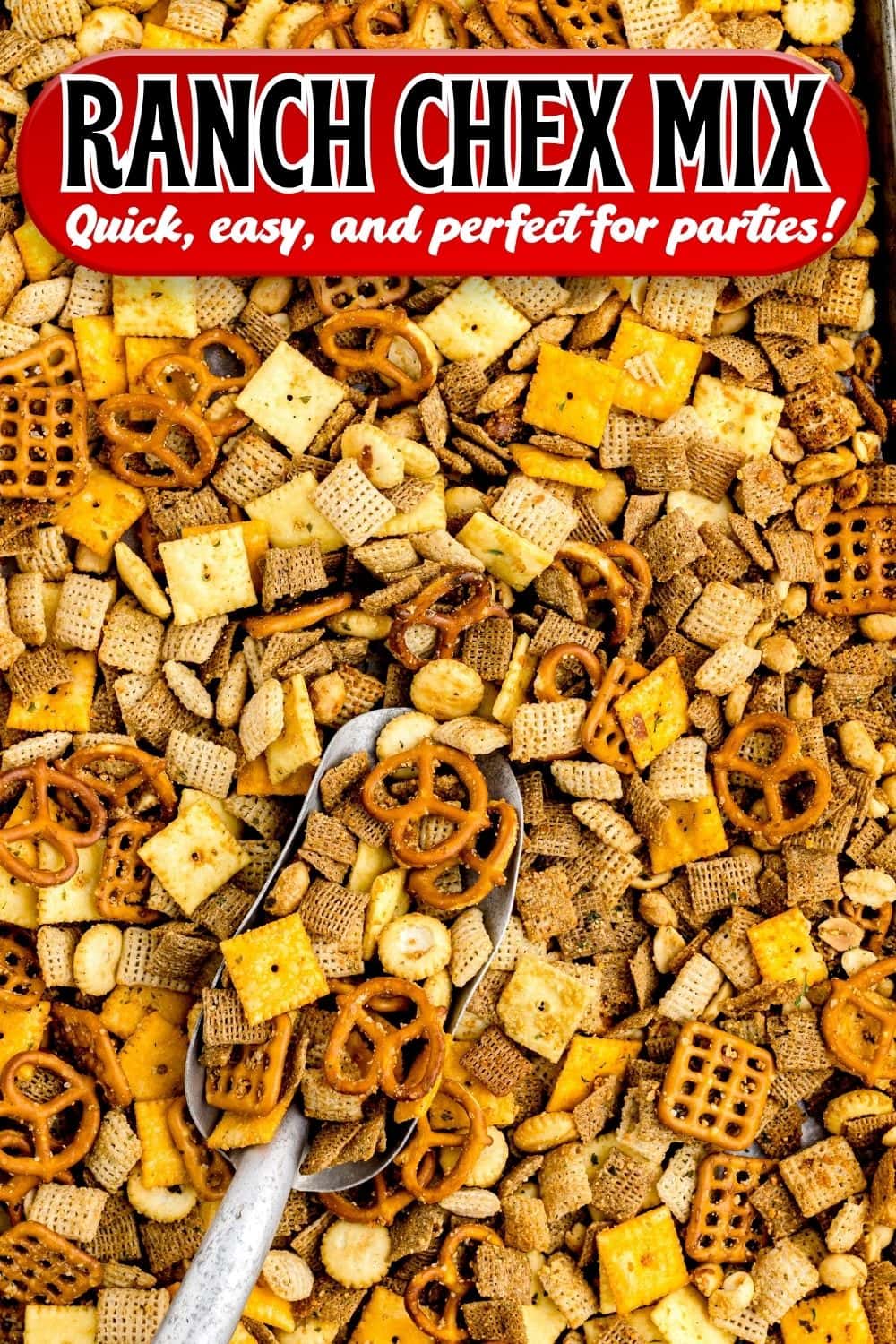 Overhead view of ranch Chex mix with pretzels, crackers, and nuts, scooped with a metal scoop.