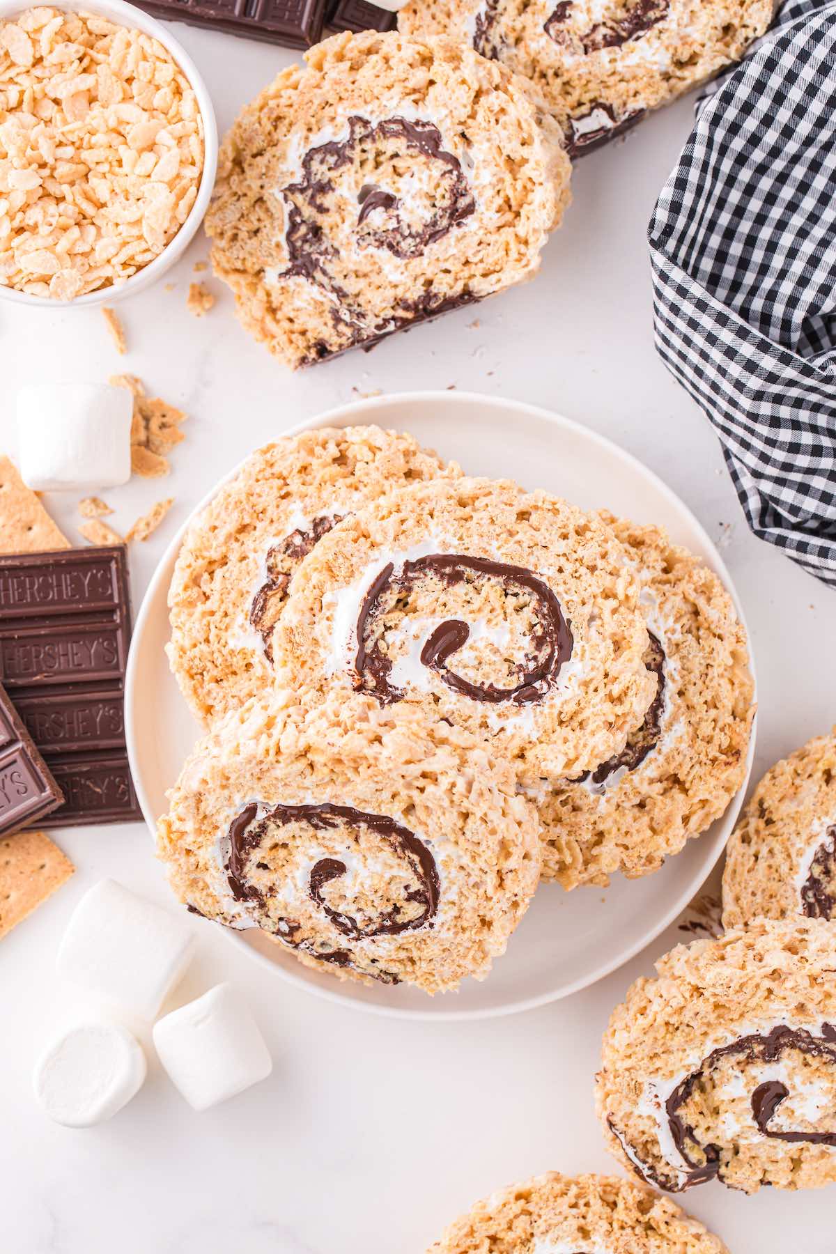 Rolled S'mores Rice Krispie Treats stacked on a plate